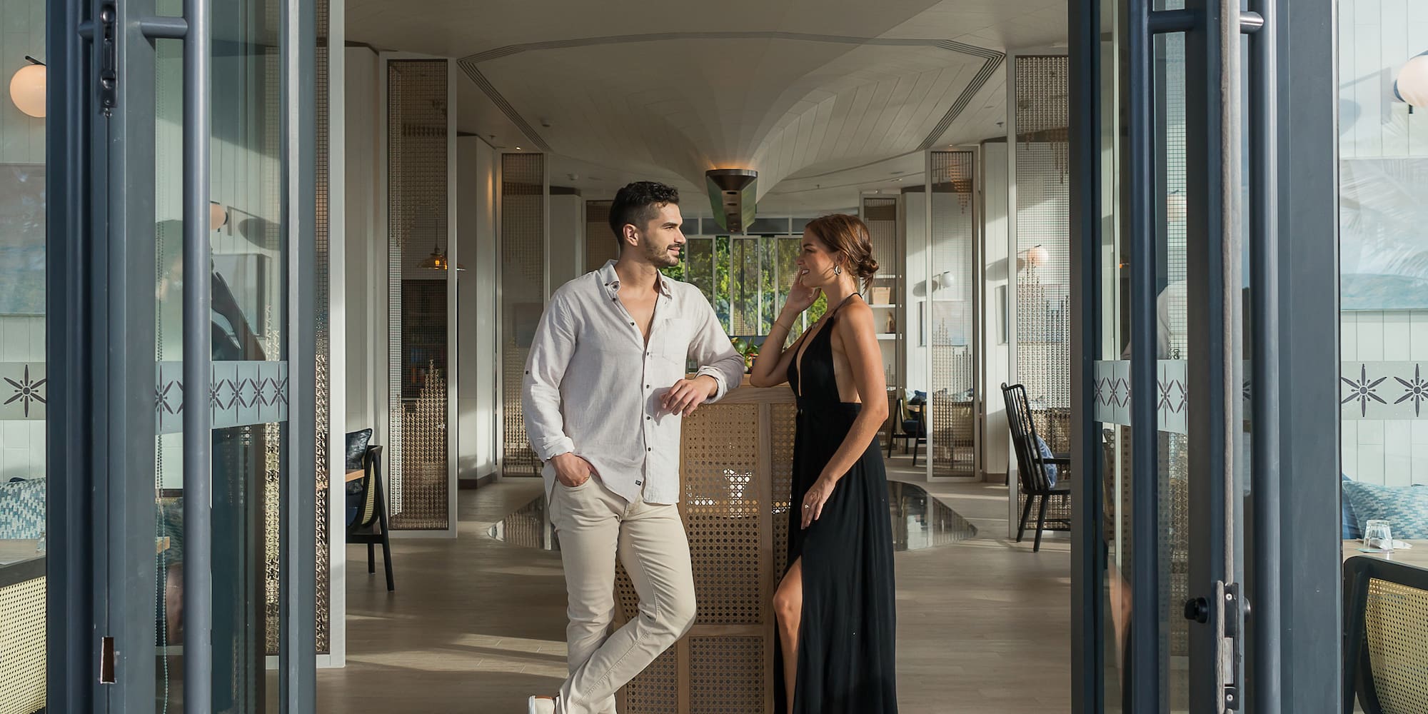 a man and woman standing in a hallway