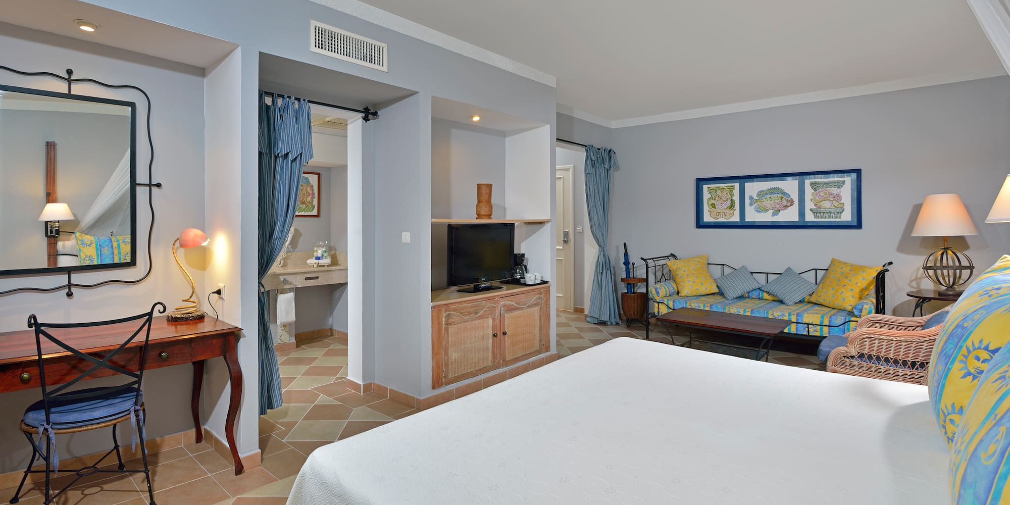 a room with a bed and a television