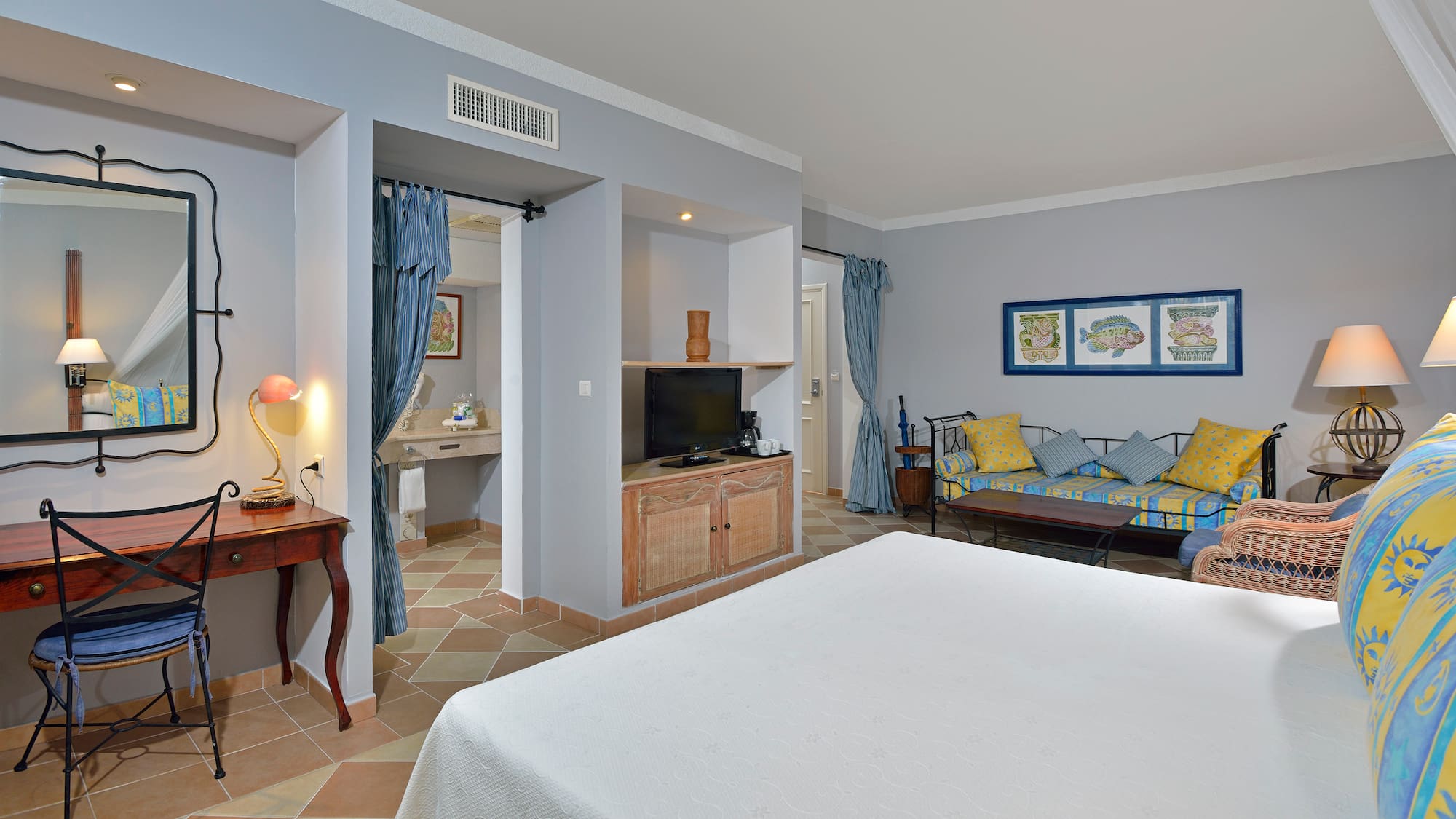 a room with a bed and a television