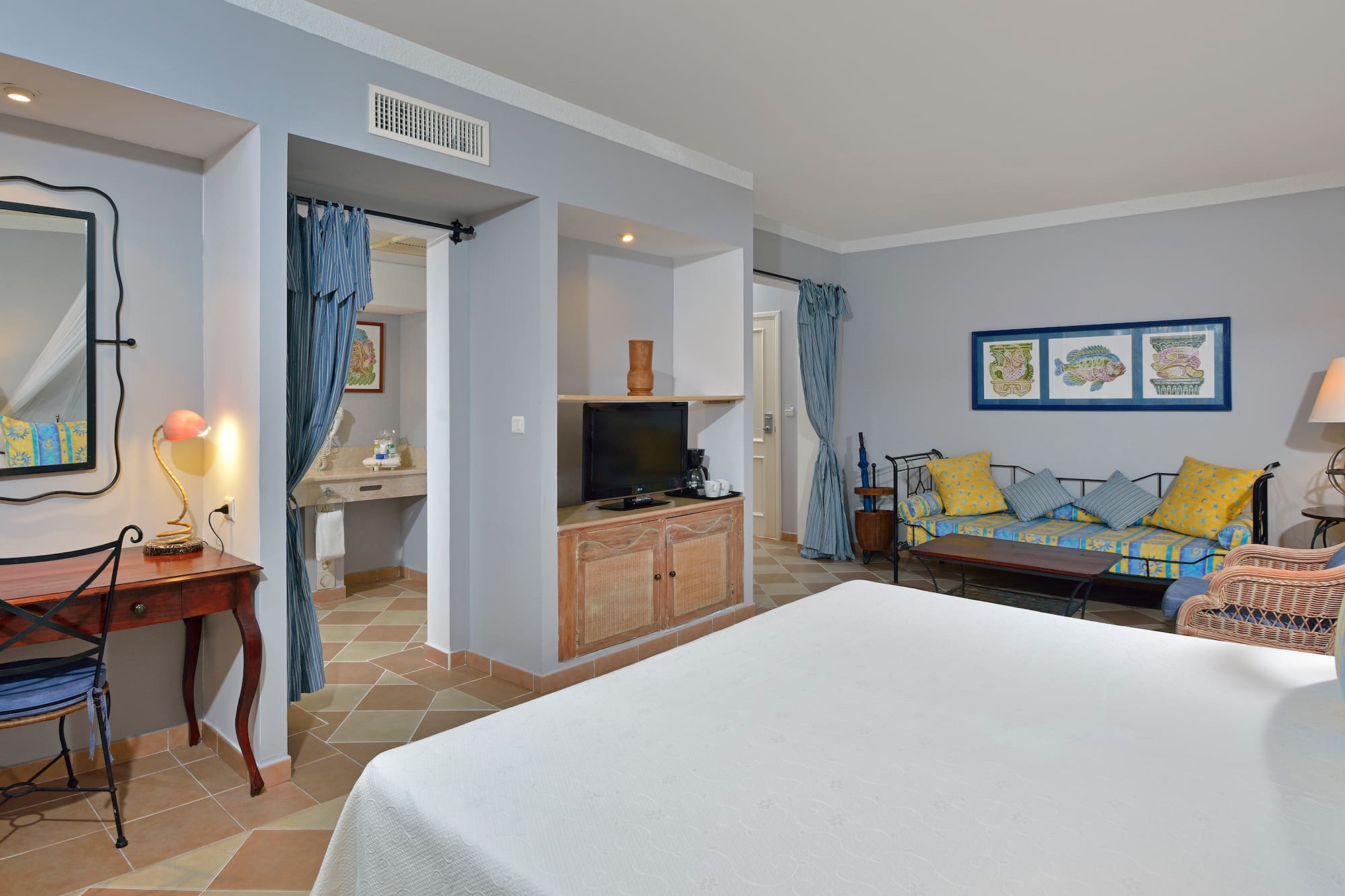 a room with a bed and a television