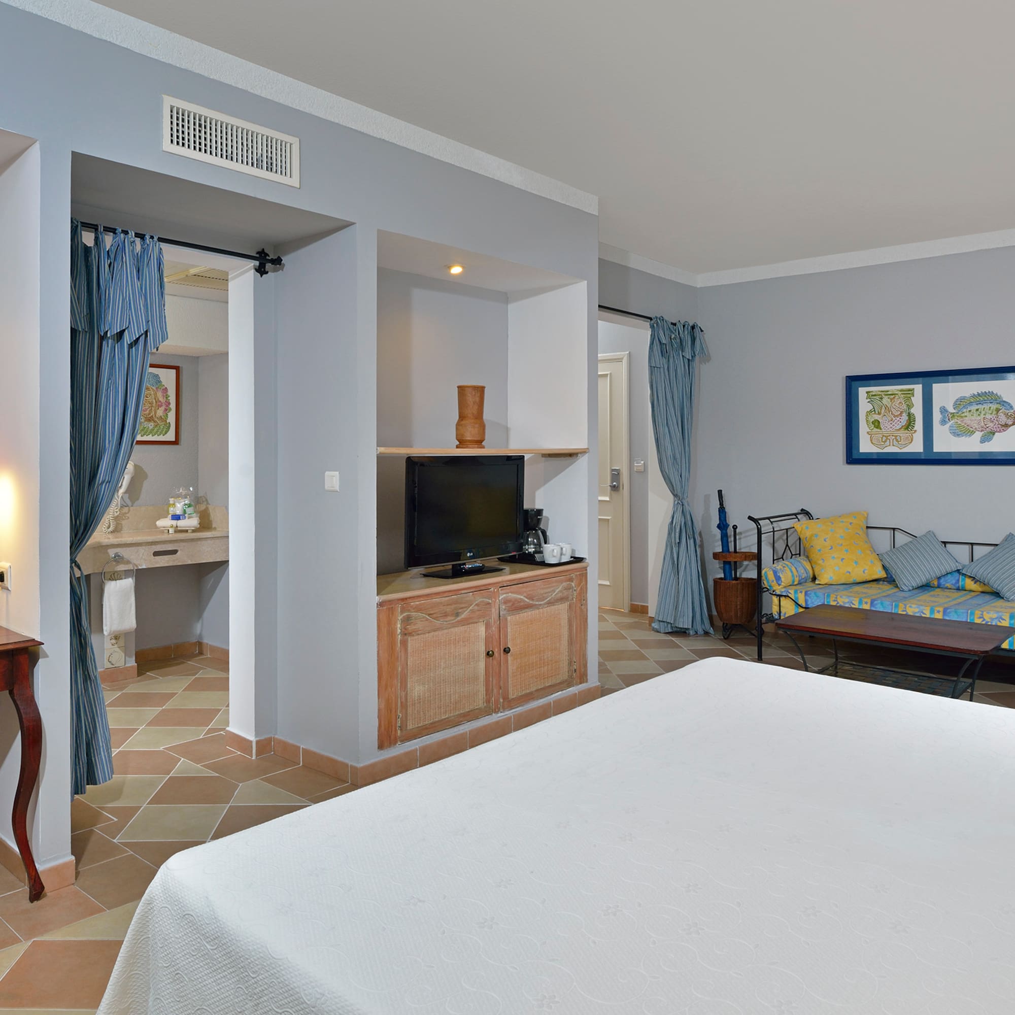 a room with a bed and a television