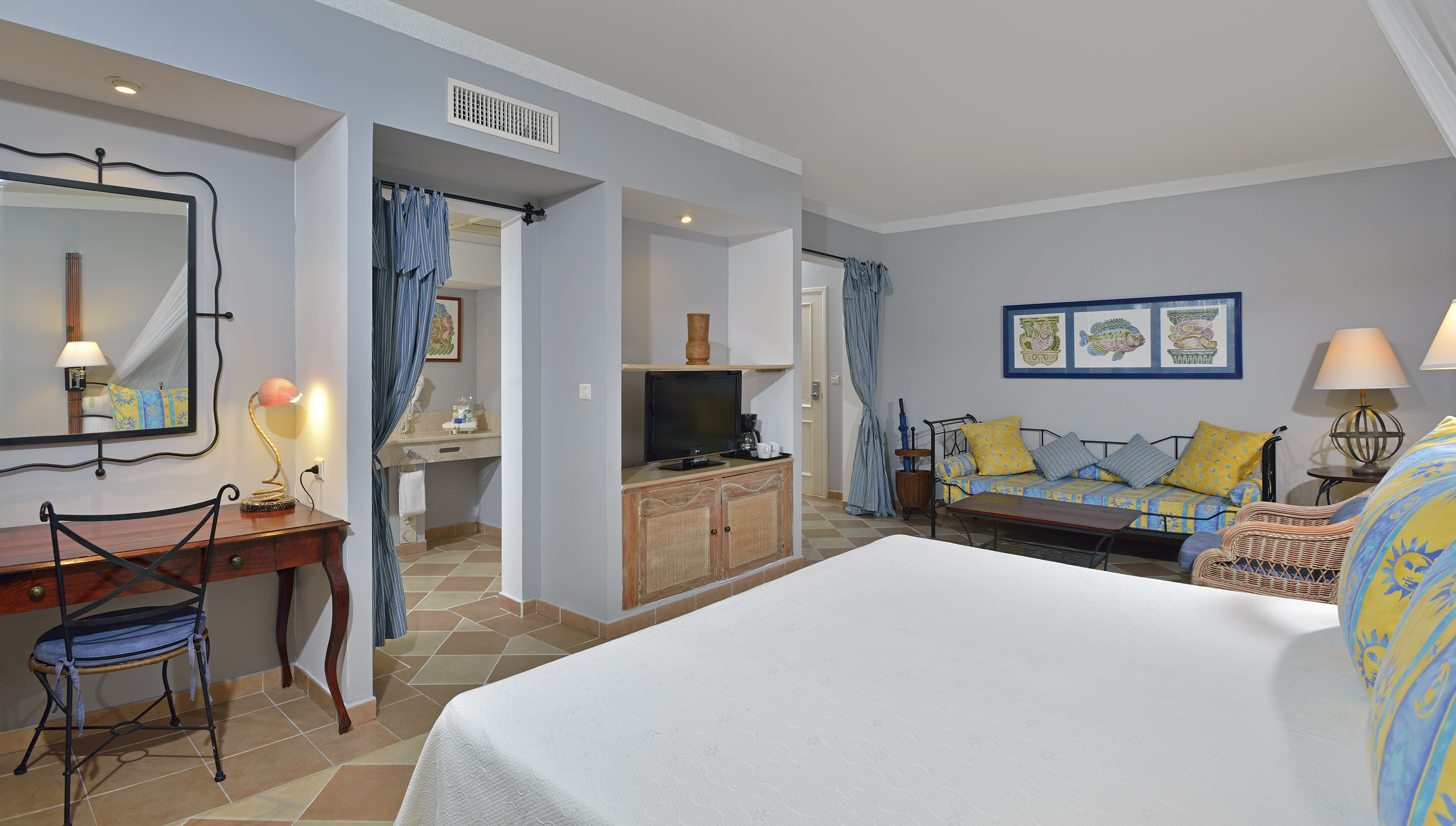 a room with a bed and a television