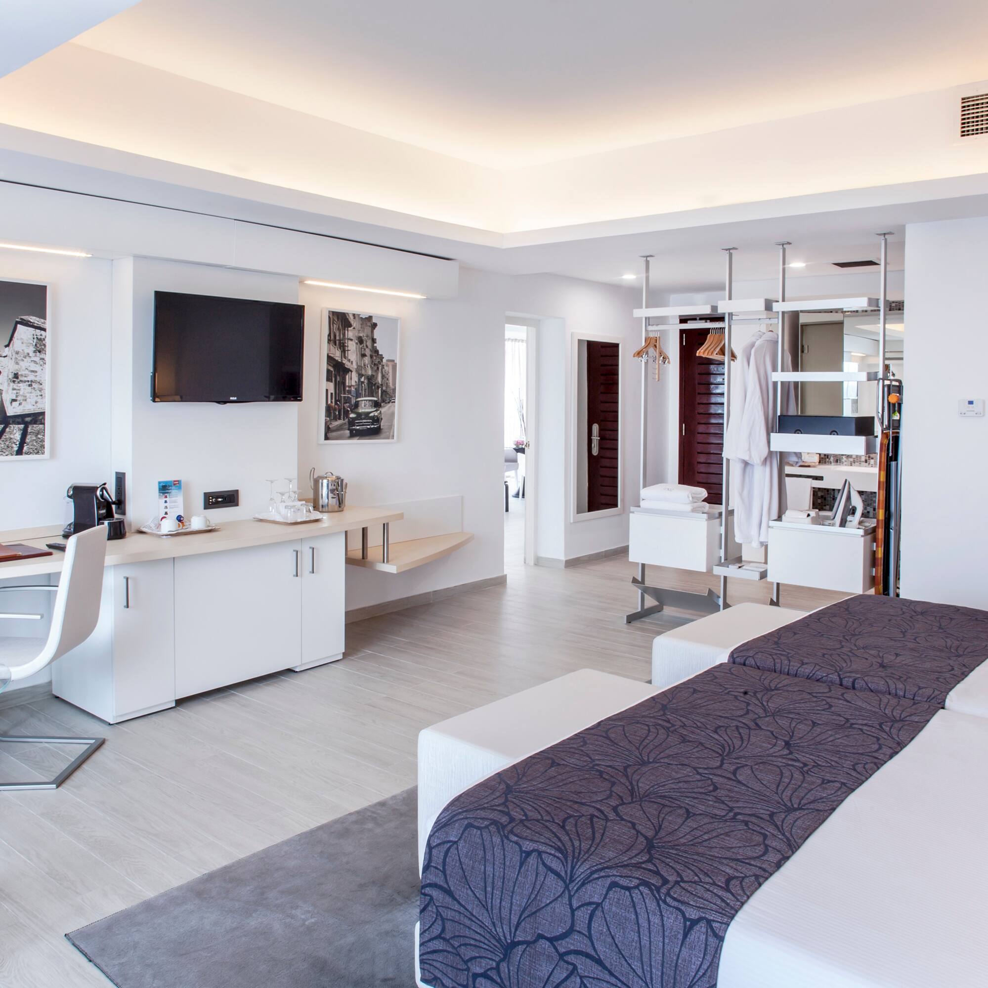 a room with two beds and a tv