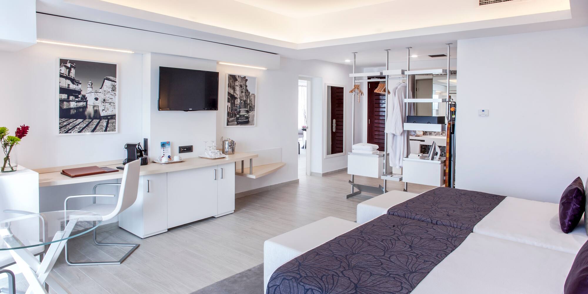 a room with two beds and a tv