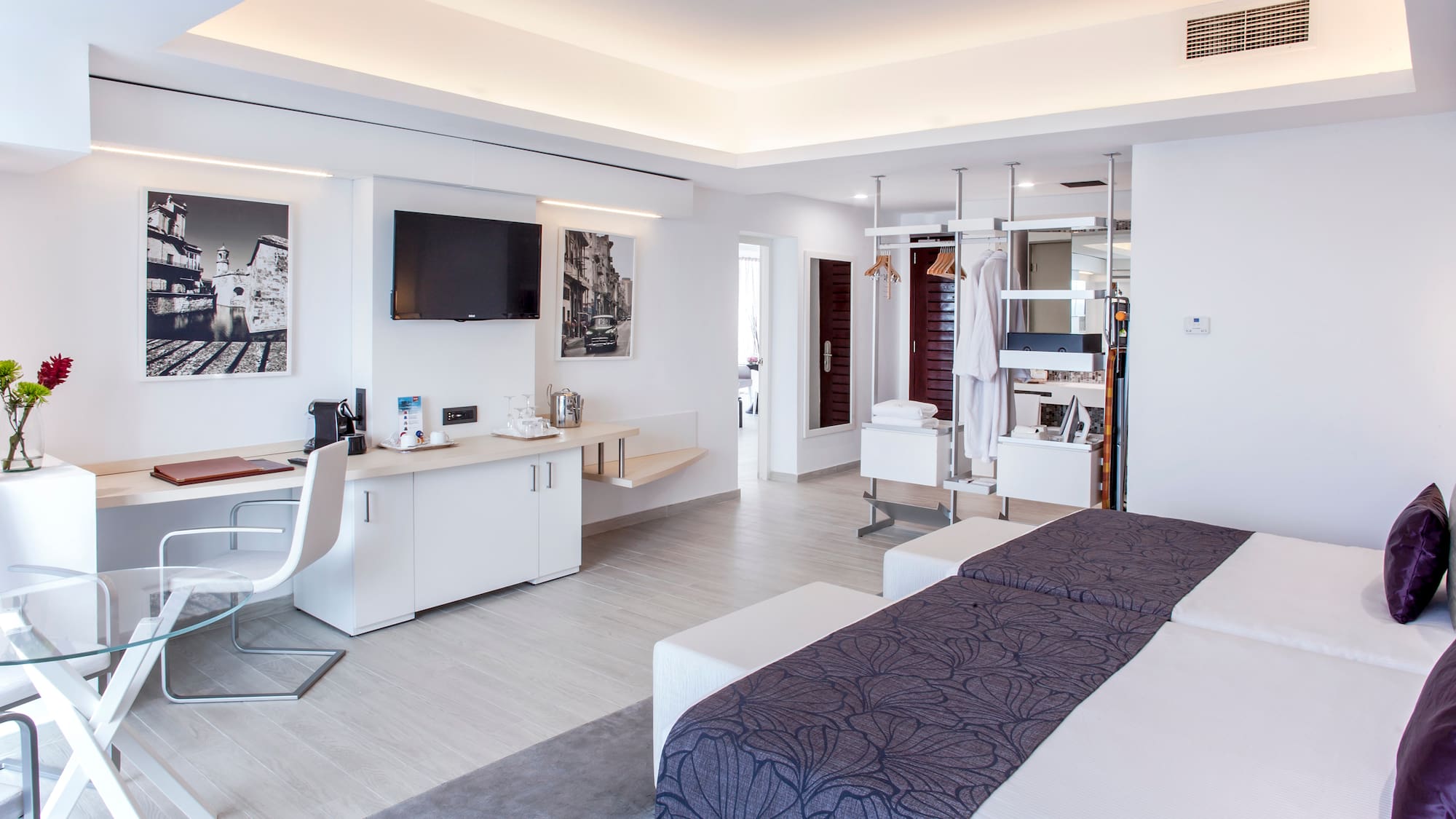 a room with two beds and a tv