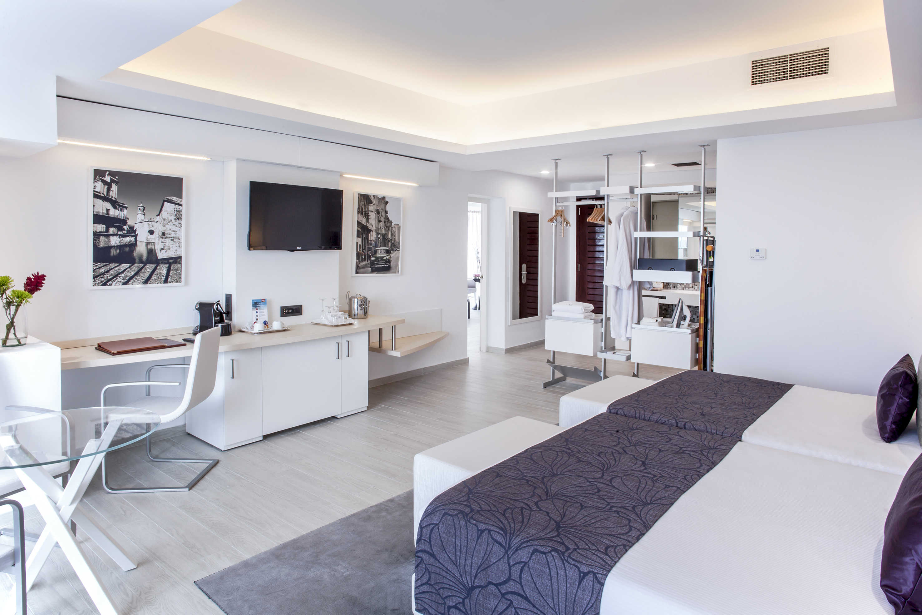 a room with two beds and a tv