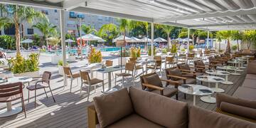 a patio with chairs and tables and umbrellas
