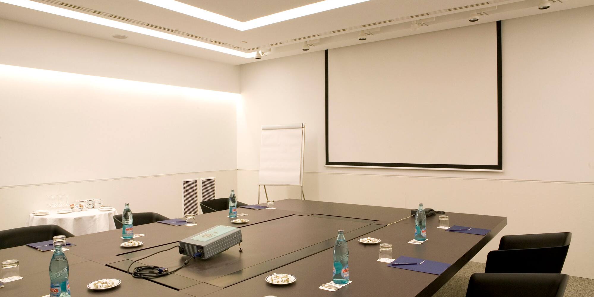 a conference room with a projector screen