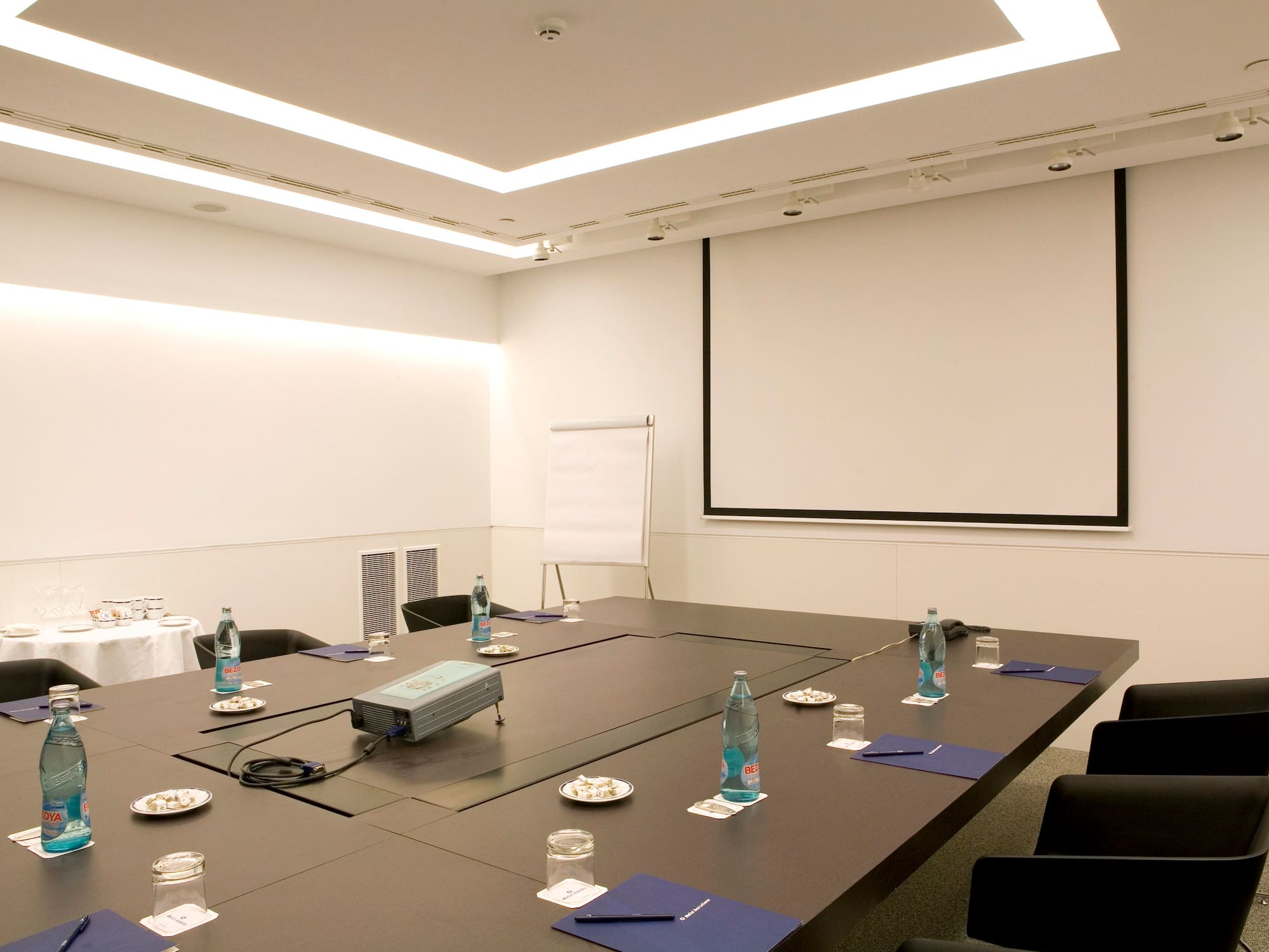 a conference room with a projector screen