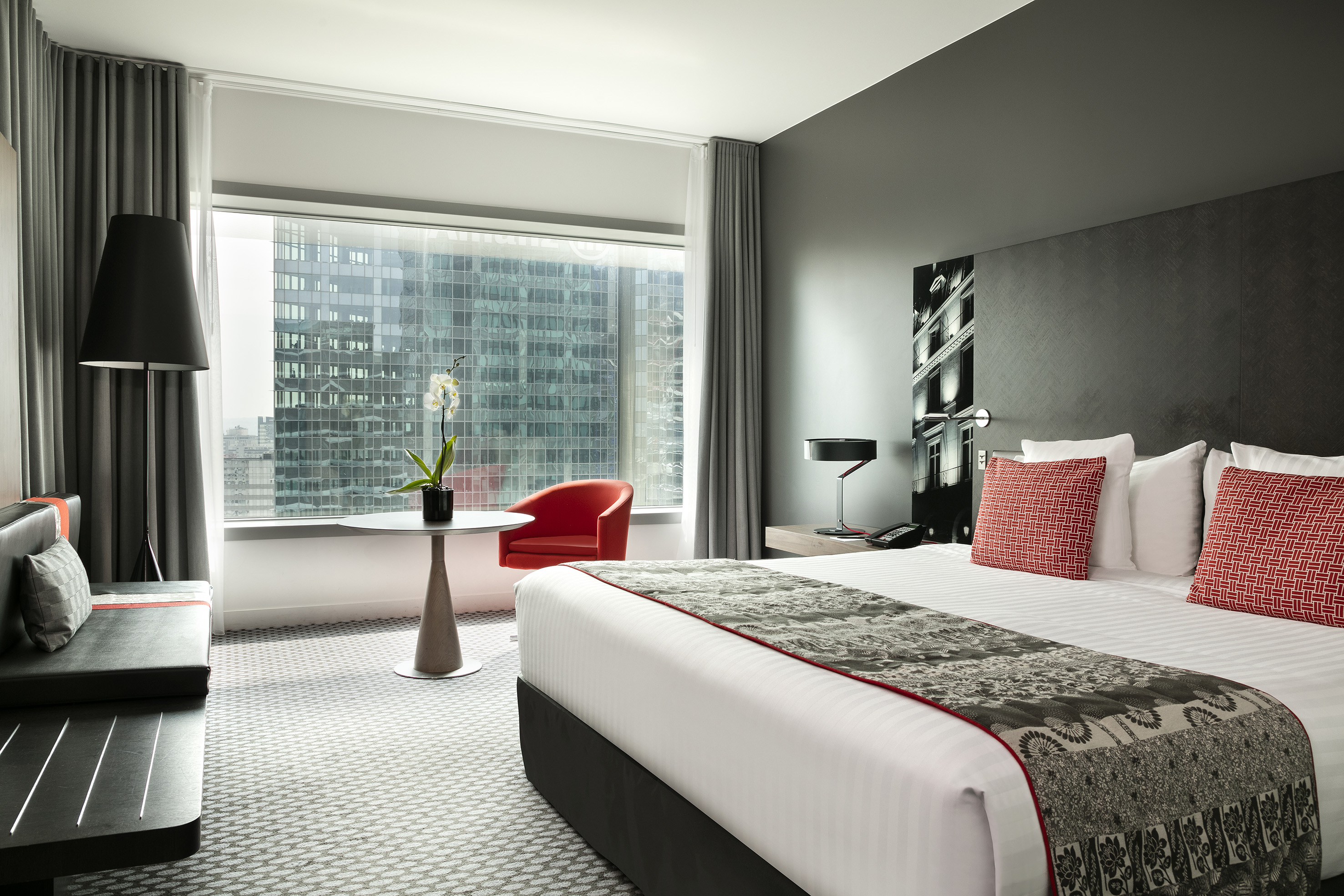 a bedroom with a large window and a bed