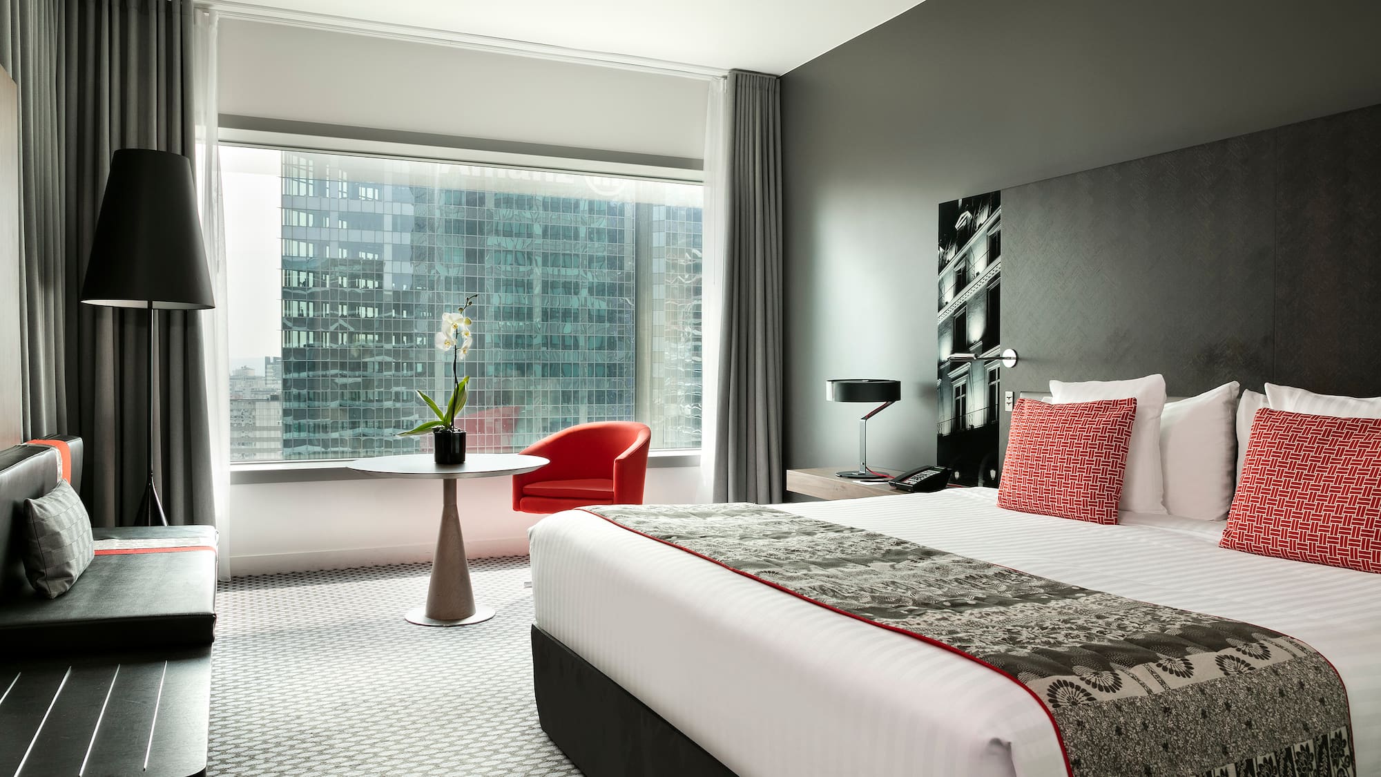 a bedroom with a large window and a bed