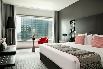 a bedroom with a large window and a bed