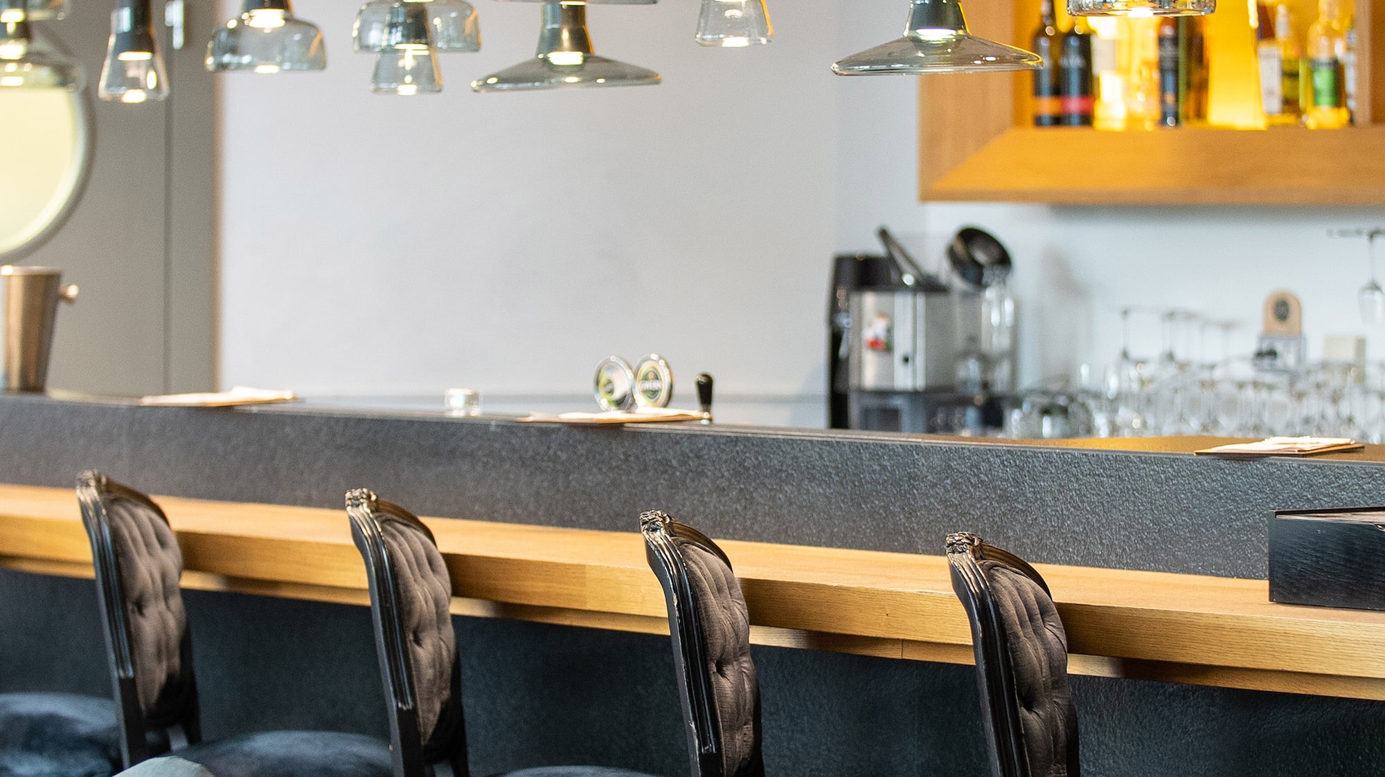 a bar with chairs and a counter