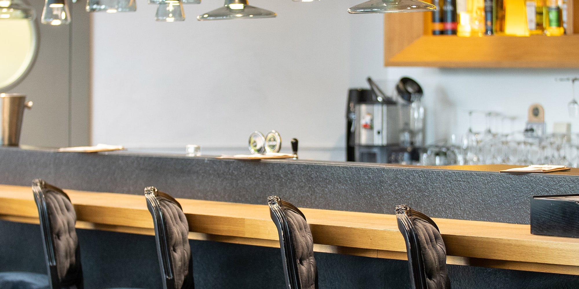 a bar with chairs and a counter
