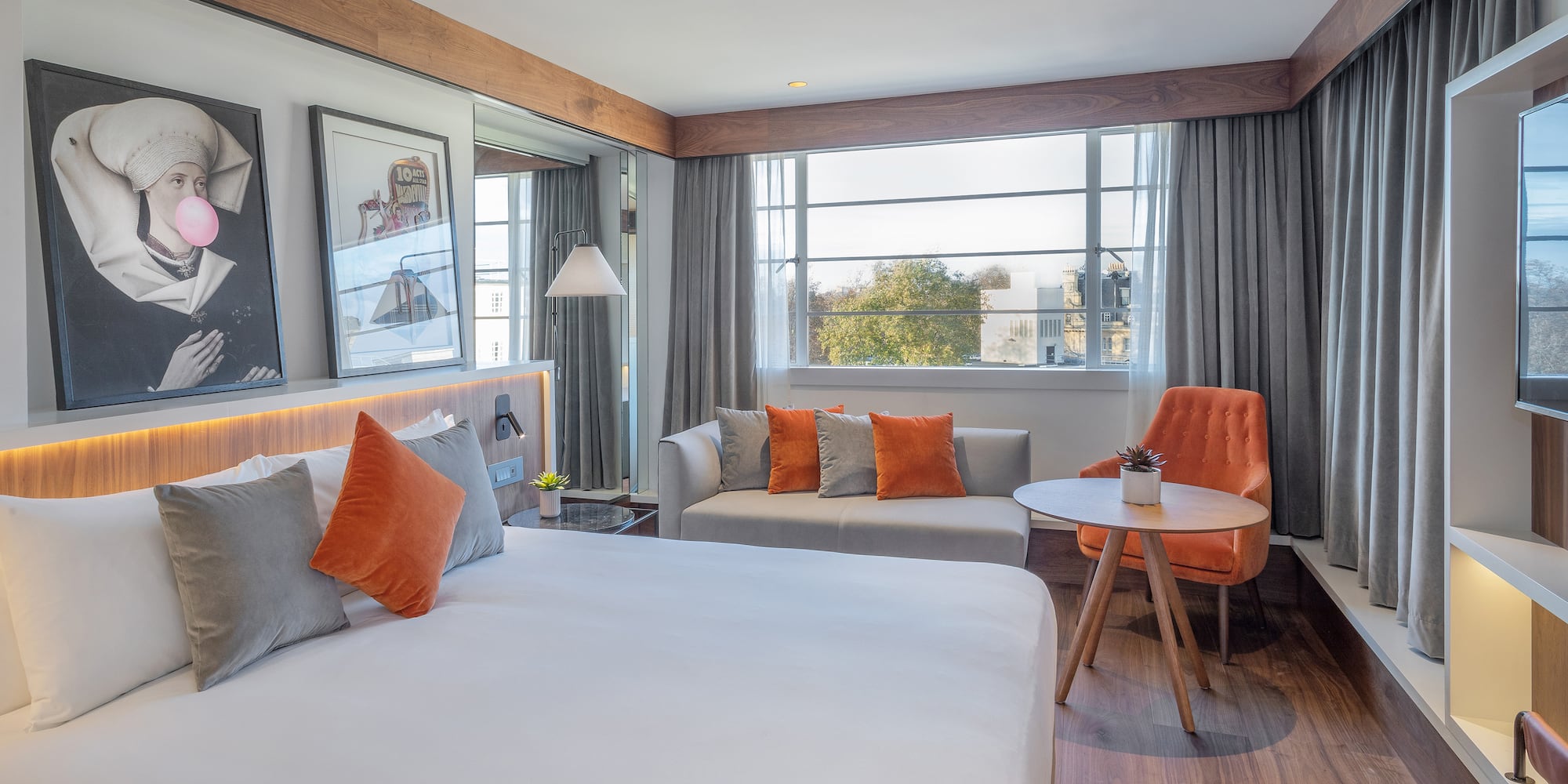 a room with a bed and a table and chairs