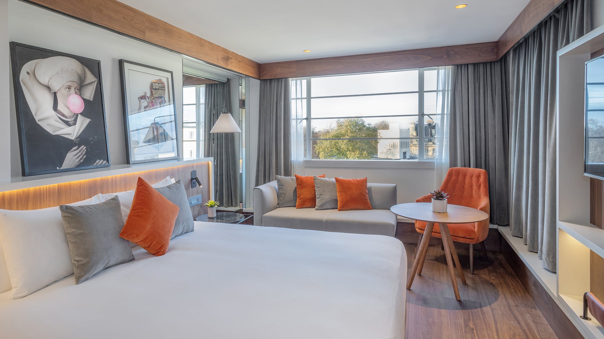 a room with a bed and a table and chairs