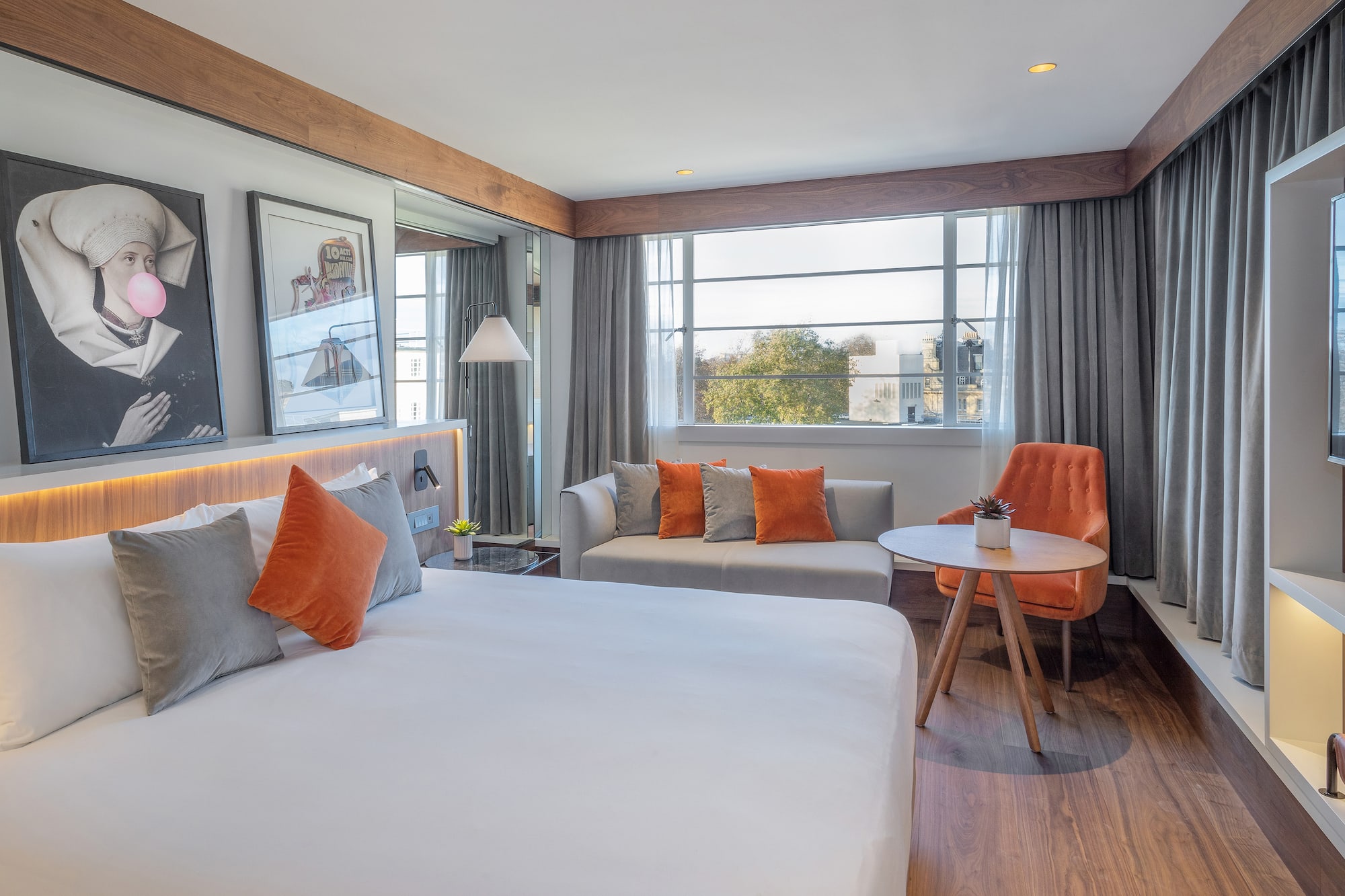 a room with a bed and a table and chairs