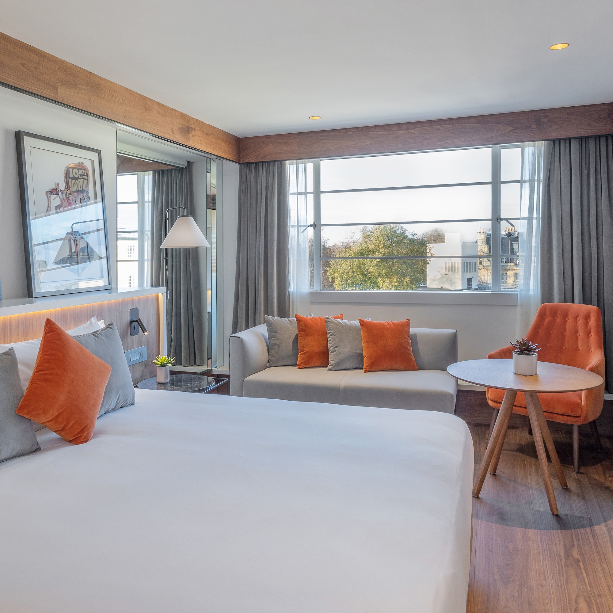 a room with a bed and a table and chairs