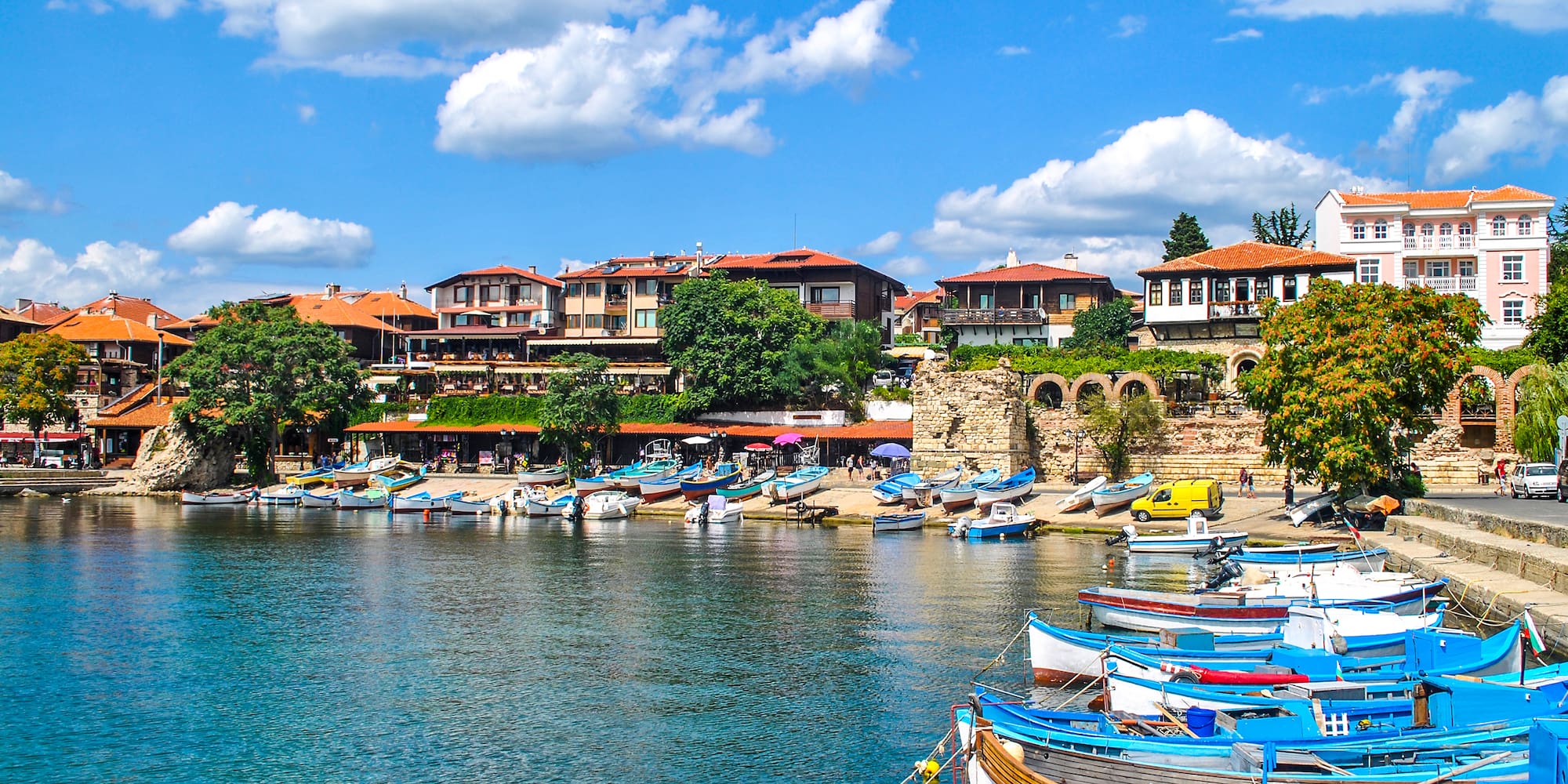 boats on the water by a city
