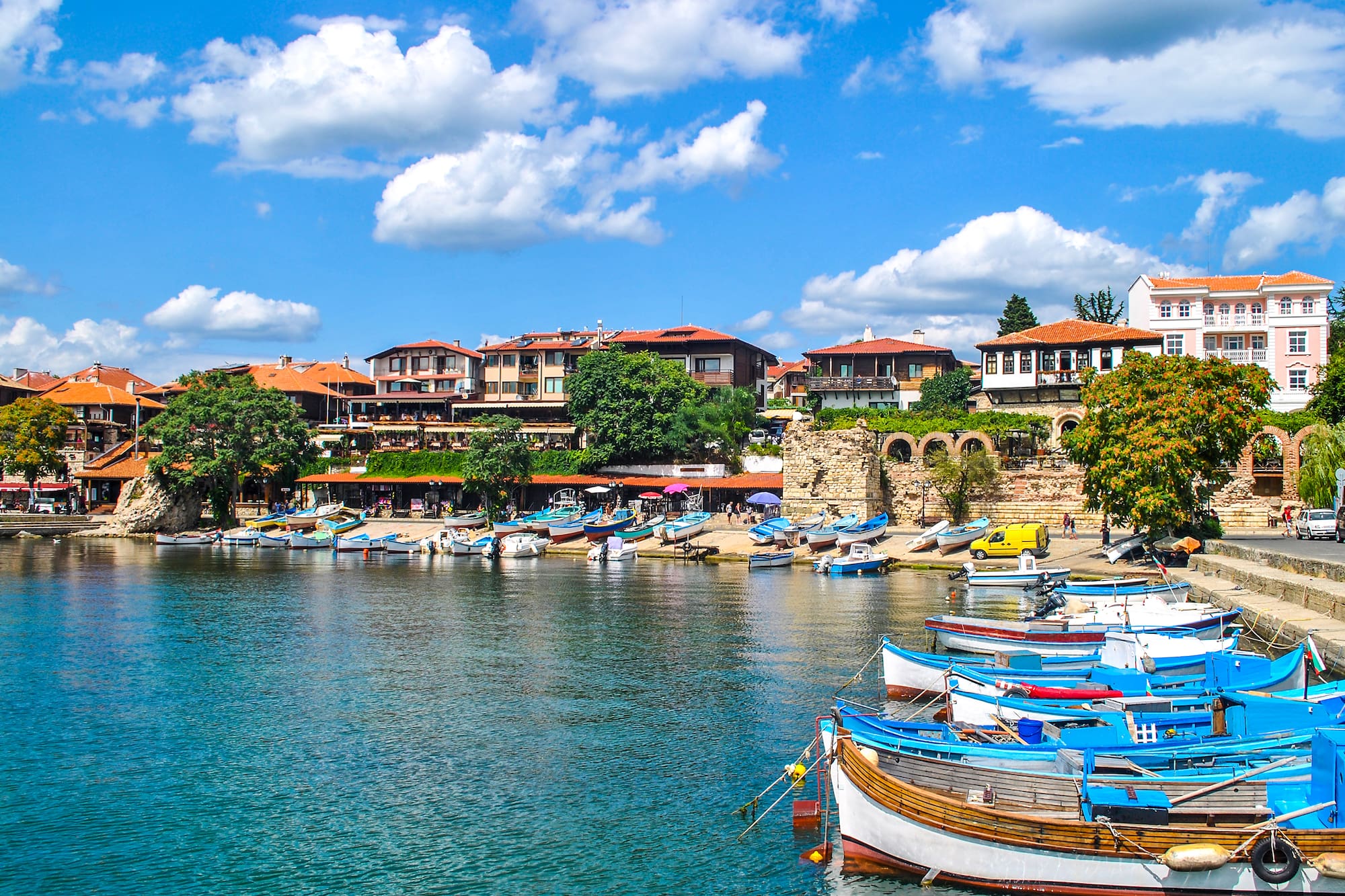 boats on the water by a city
