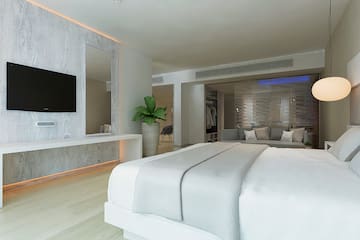 a room with a large bed and a television