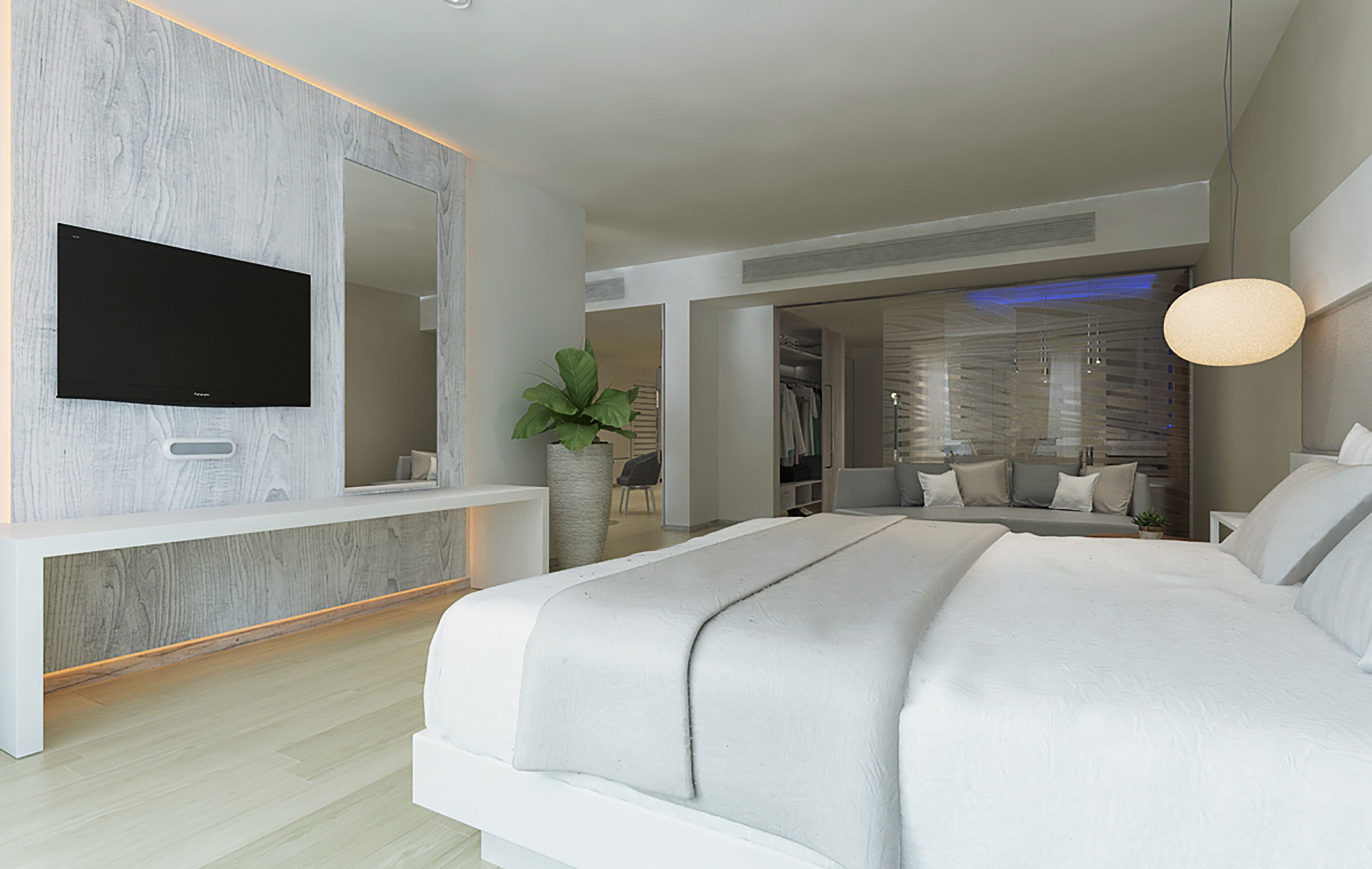 a room with a large bed and a television