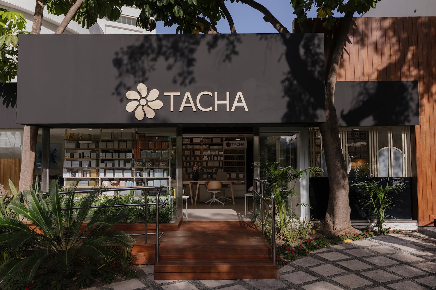 a store front with a sign and a bookcase