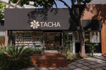 a store front with a sign and a bookcase