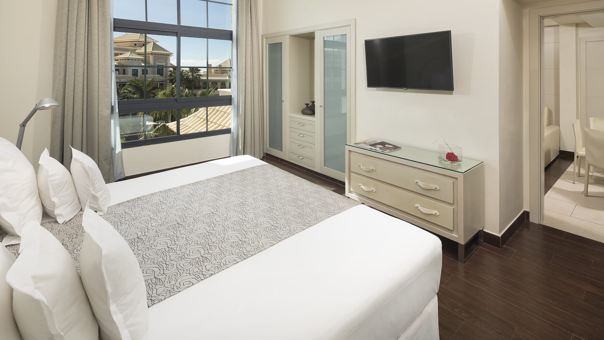 a bedroom with a television and a bed