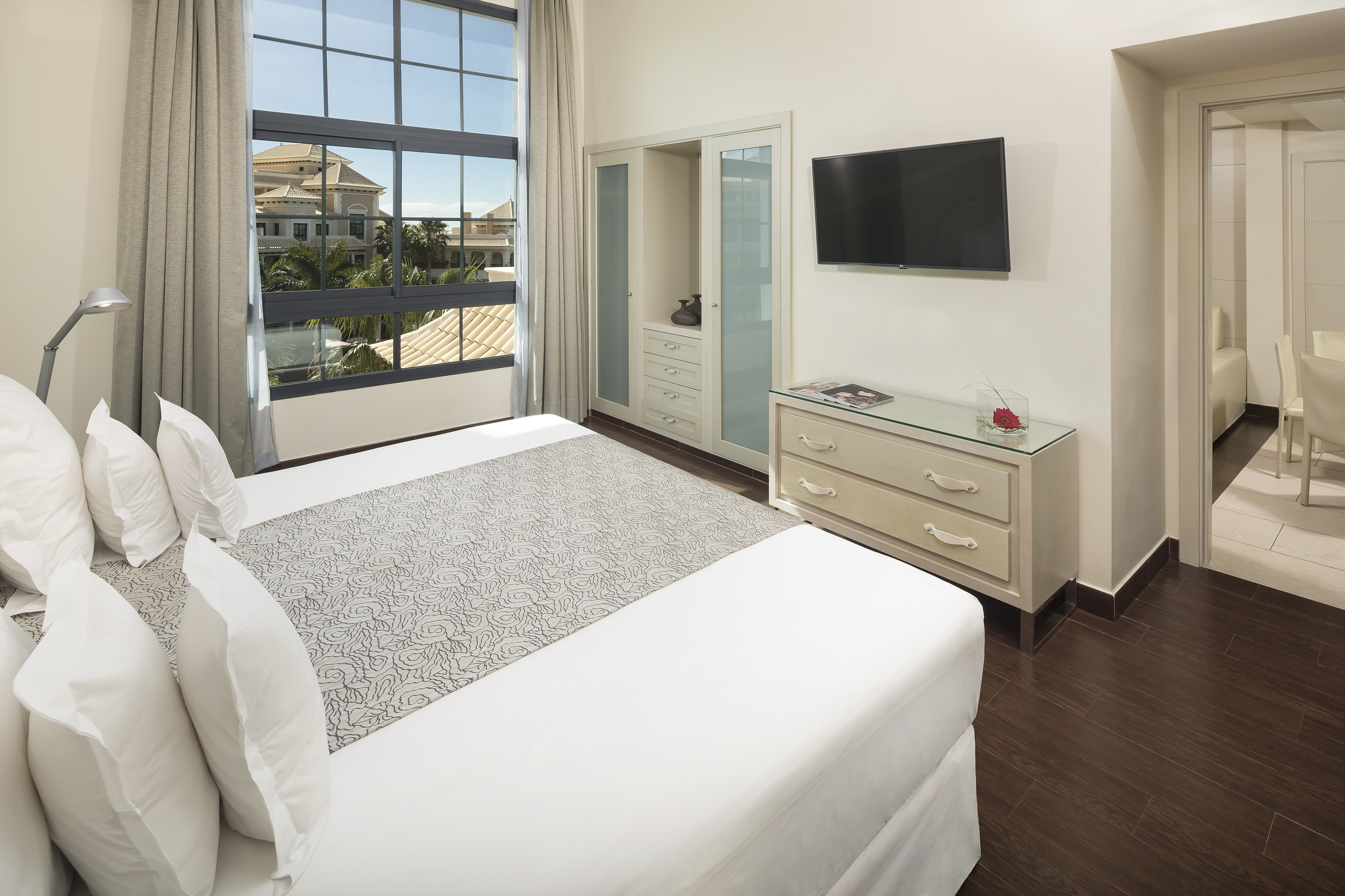 a bedroom with a television and a bed.