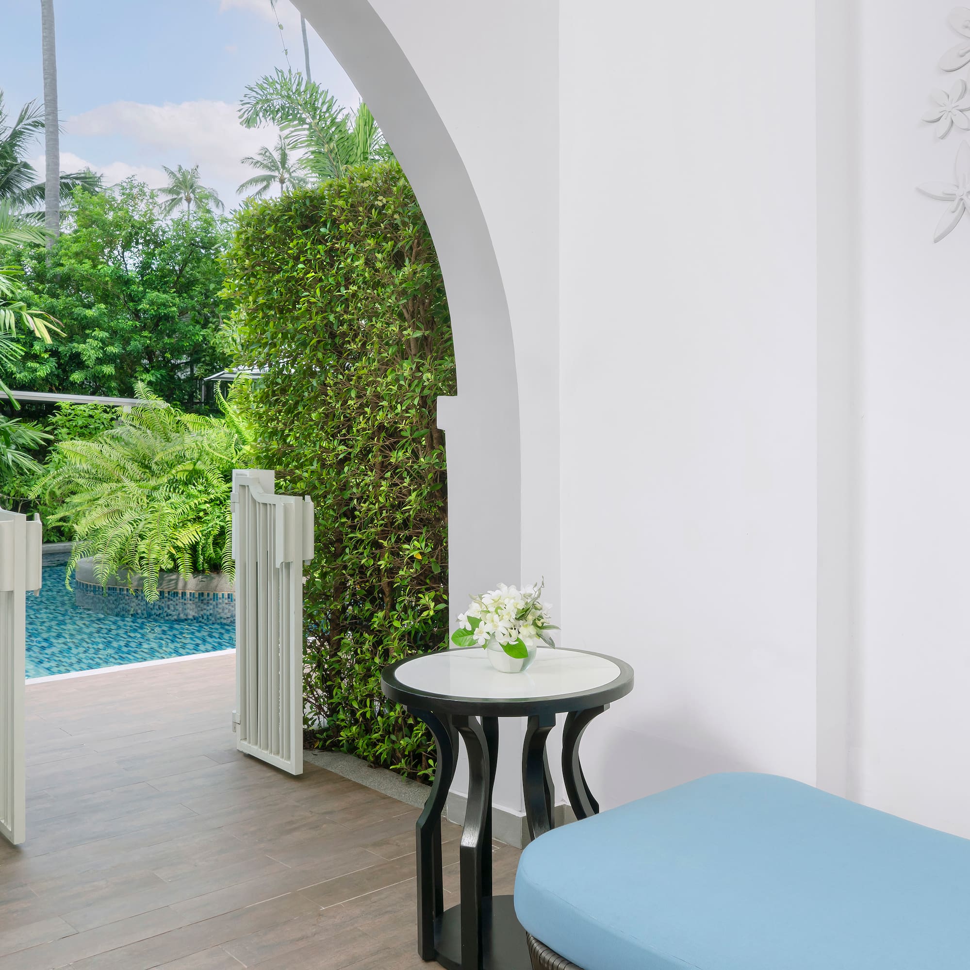 a patio with a pool and a table