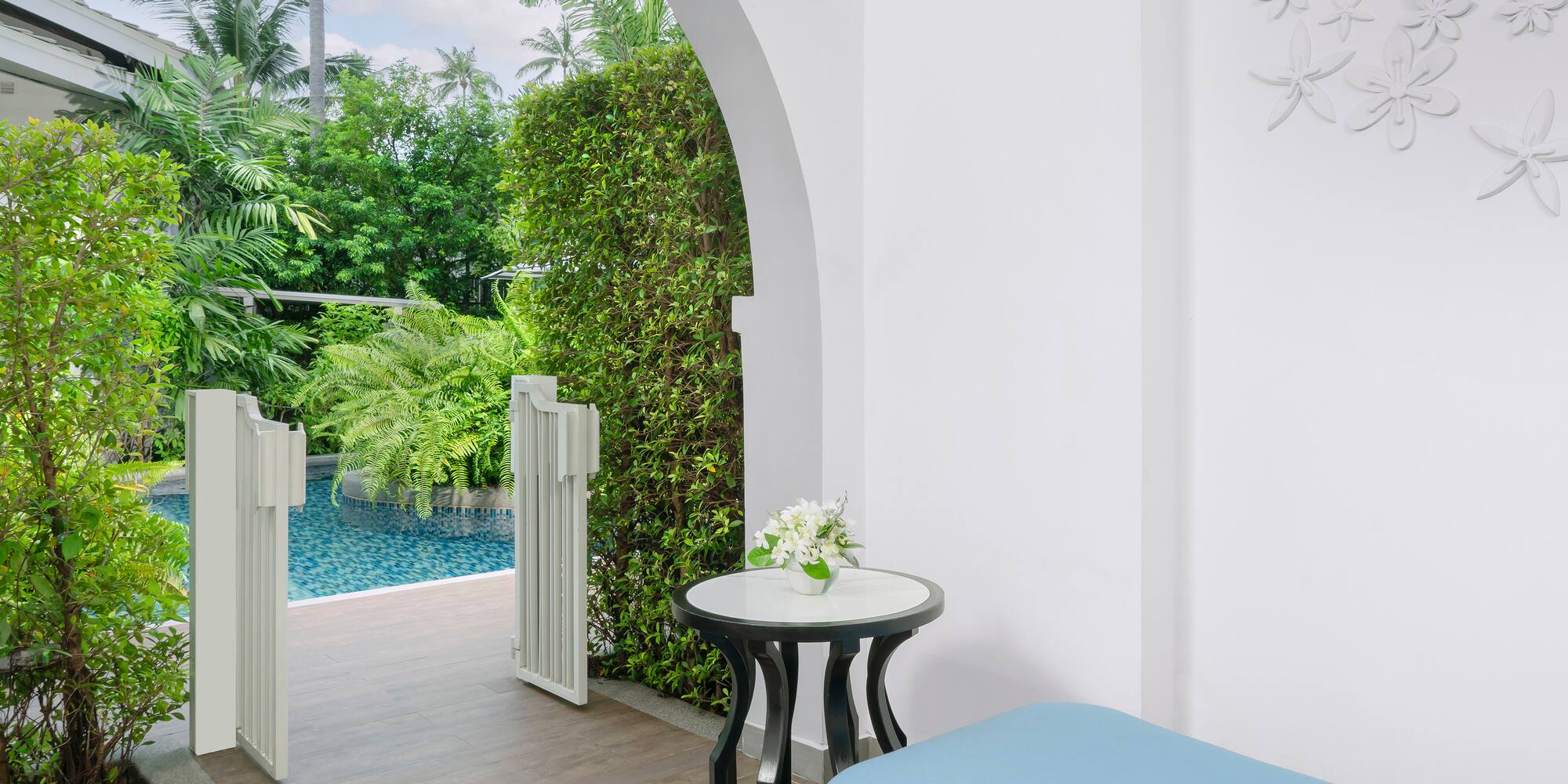 a patio with a pool and a table