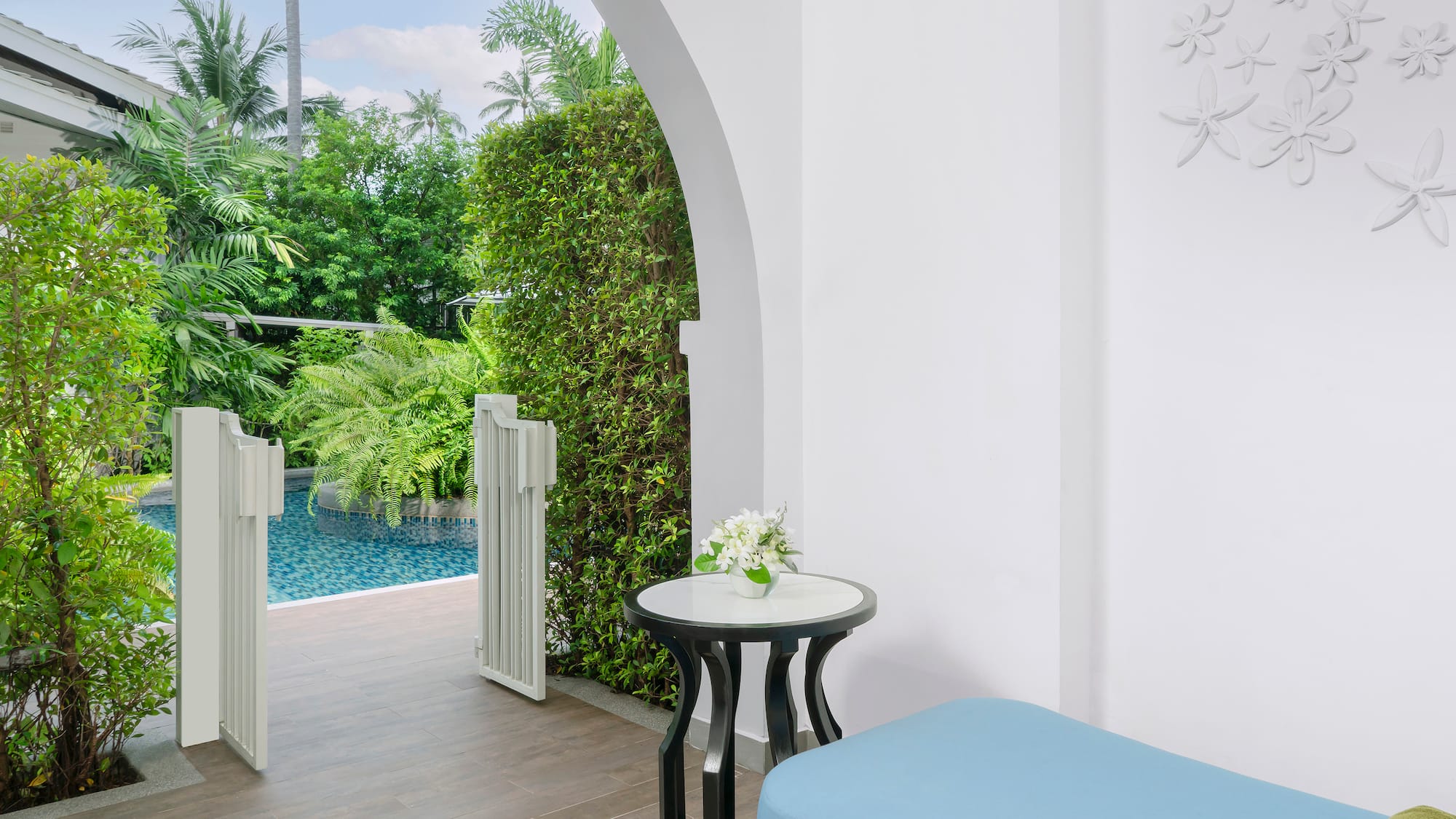 a patio with a pool and a table