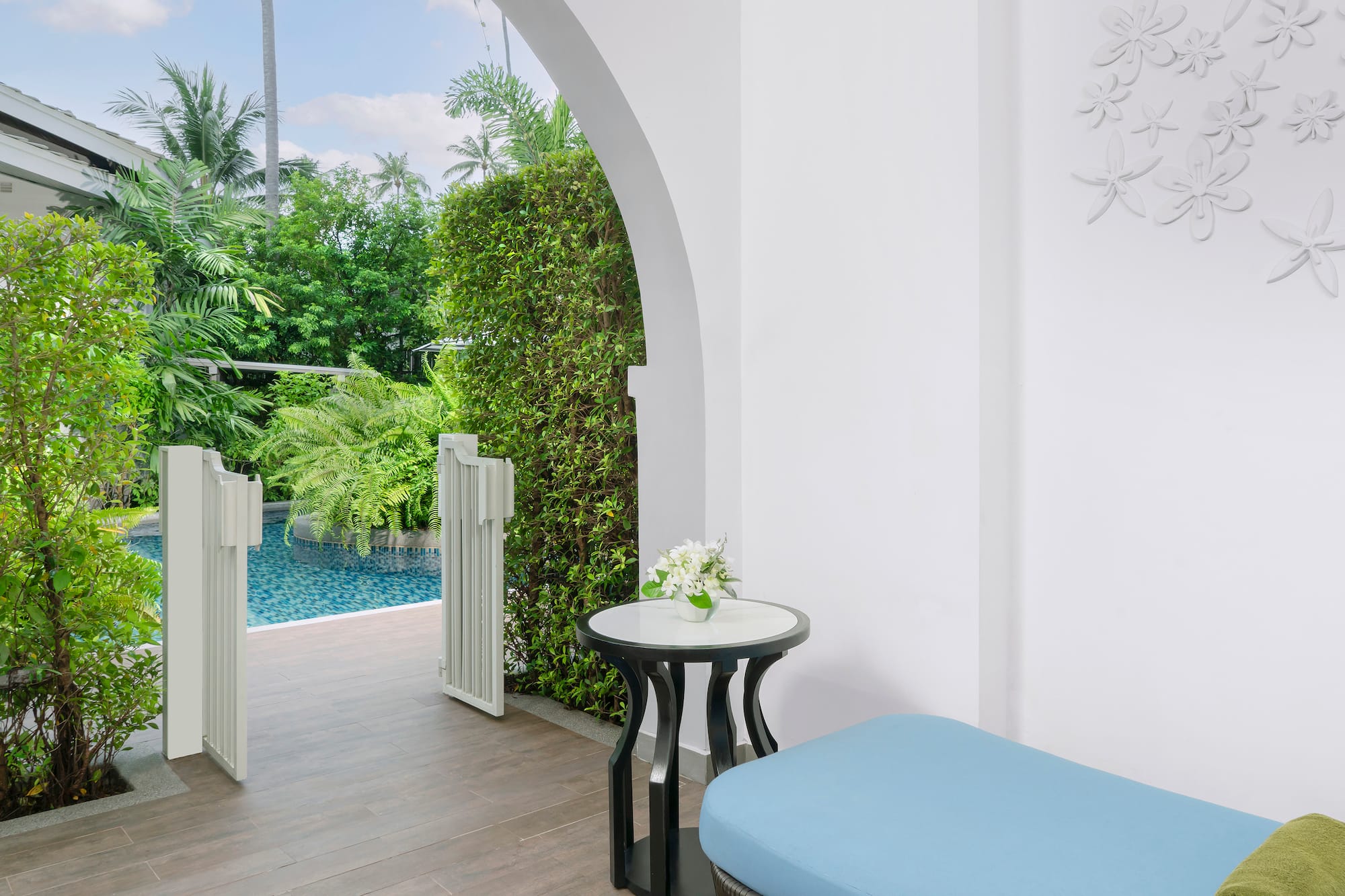 a patio with a pool and a table