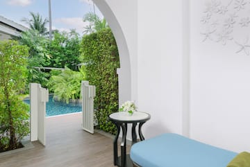 a patio with a pool and a table