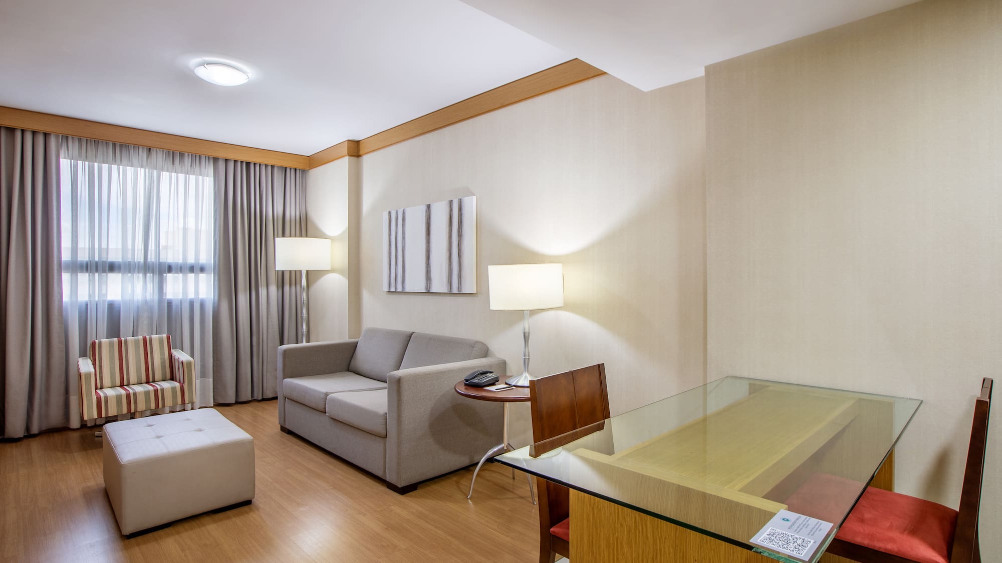 a room with a glass table and couches