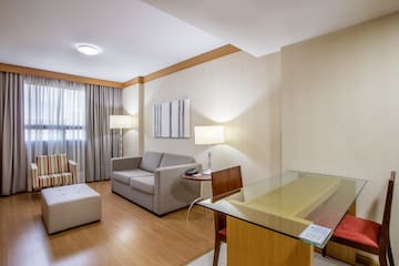 a room with a glass table and couches