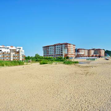 a beach with buildings and sand