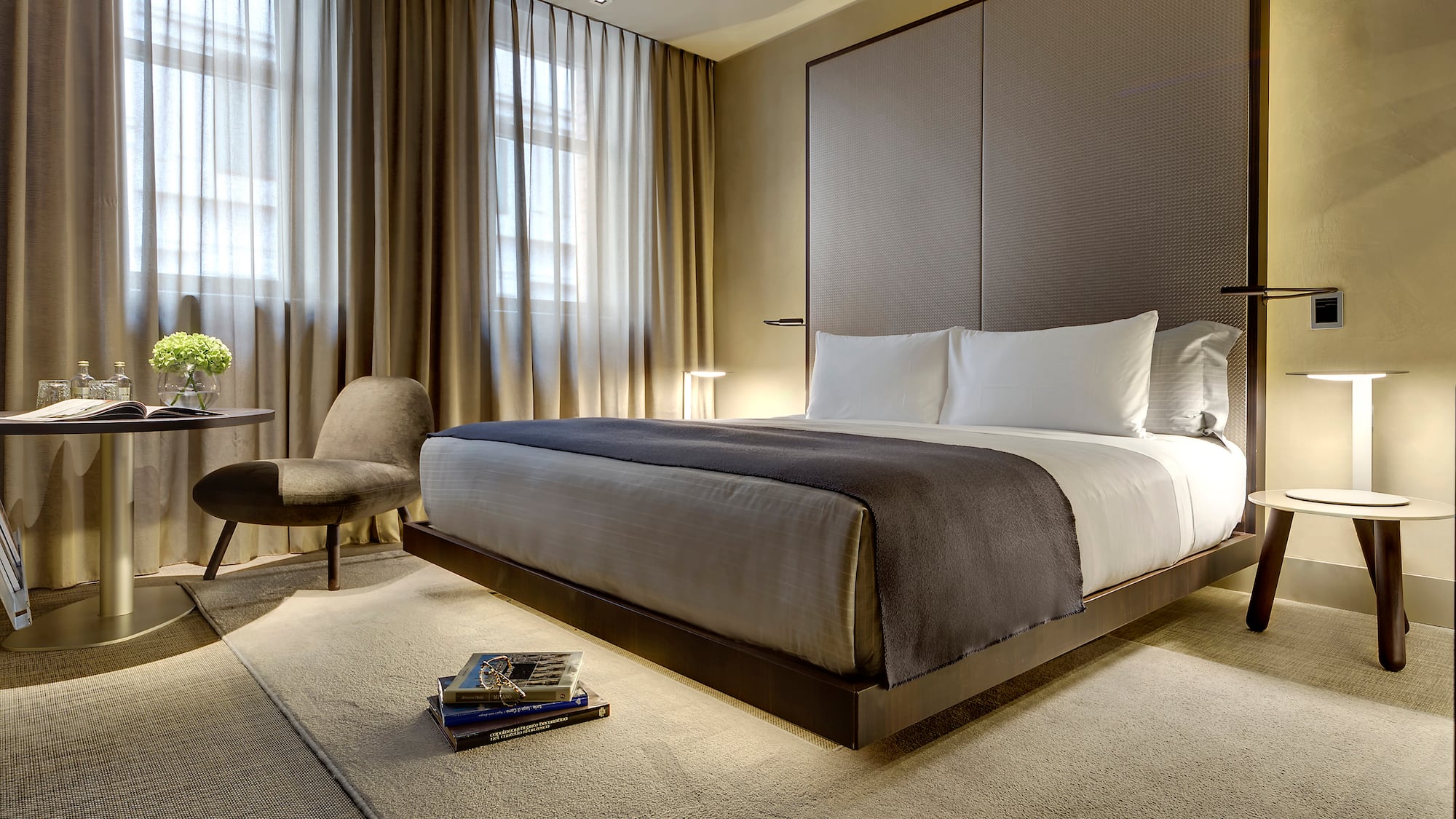 a bedroom with a bed and a chair