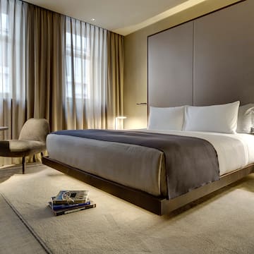 a bedroom with a bed and a chair