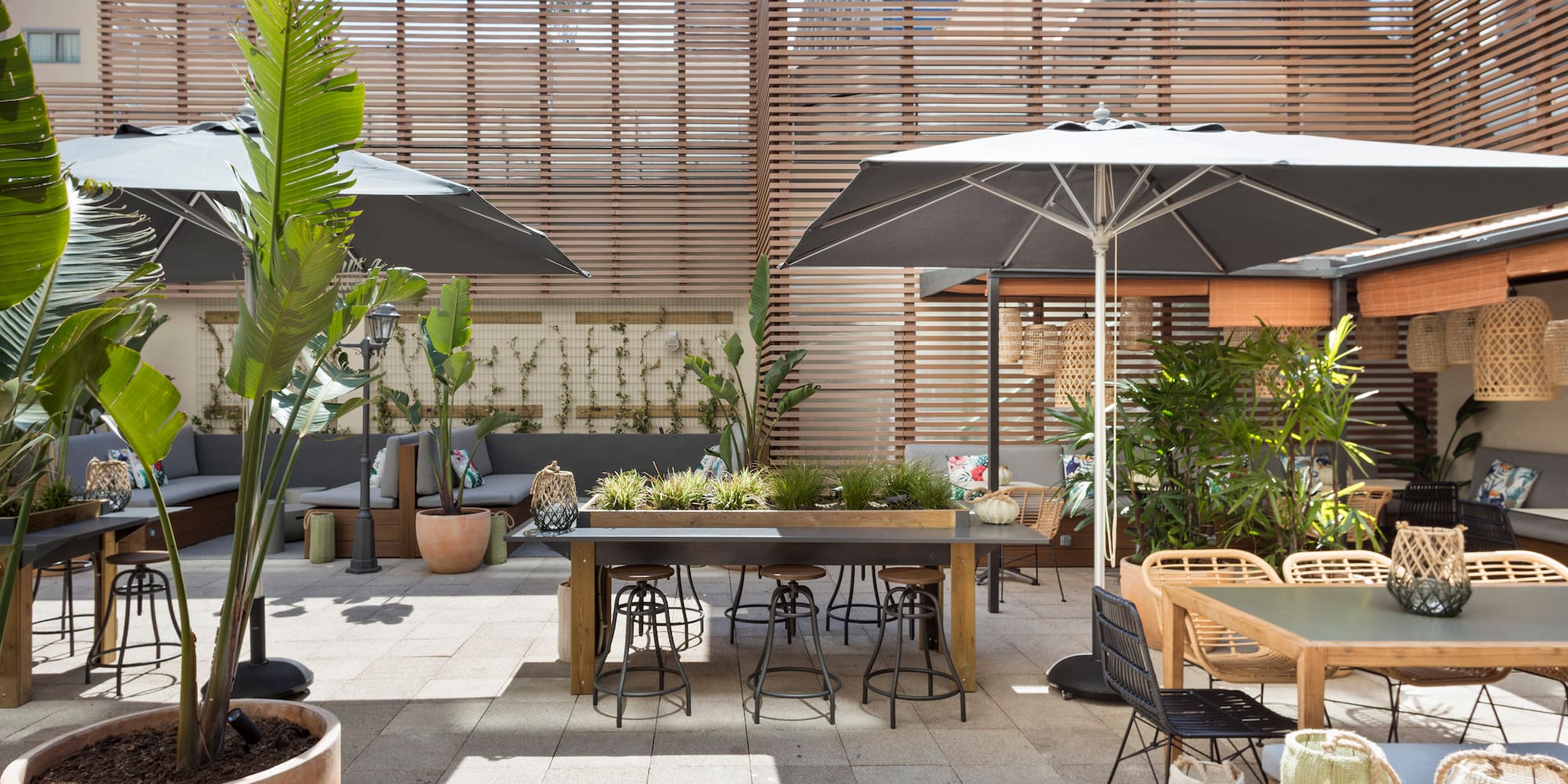 a patio with tables and umbrellas