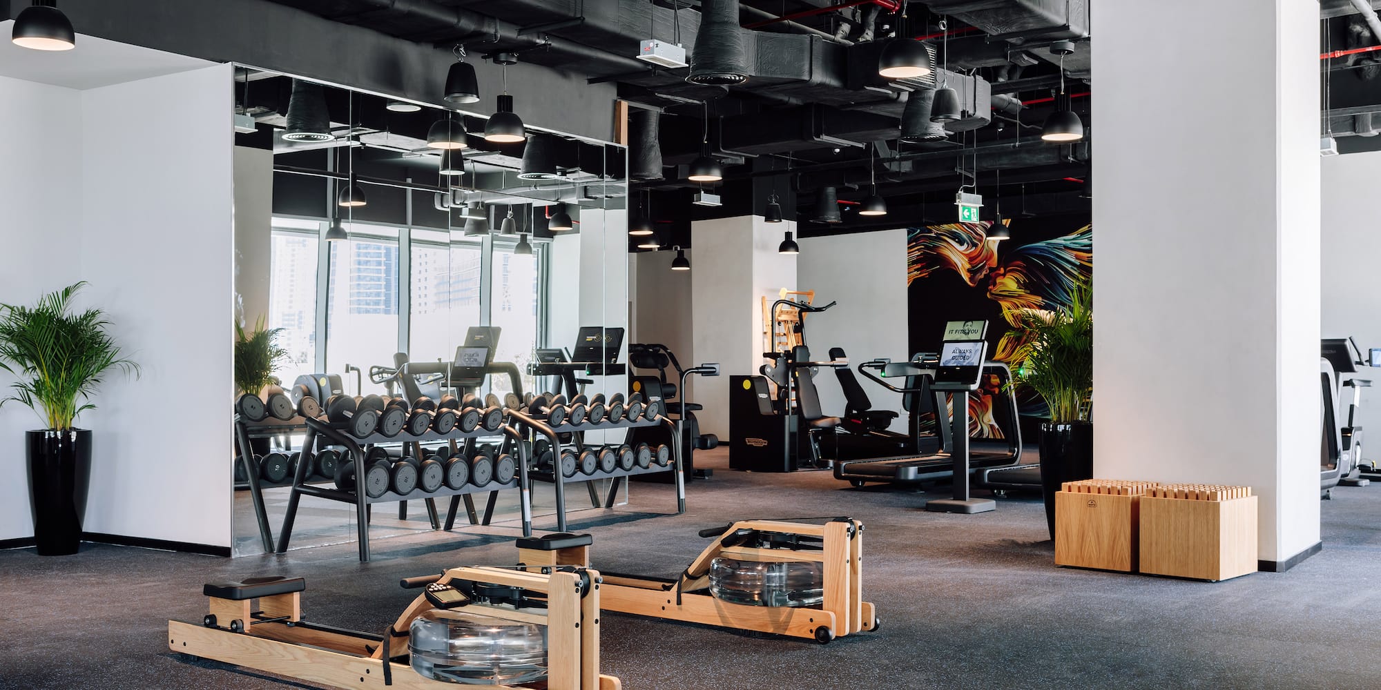 a room with a gym equipment and a mirror