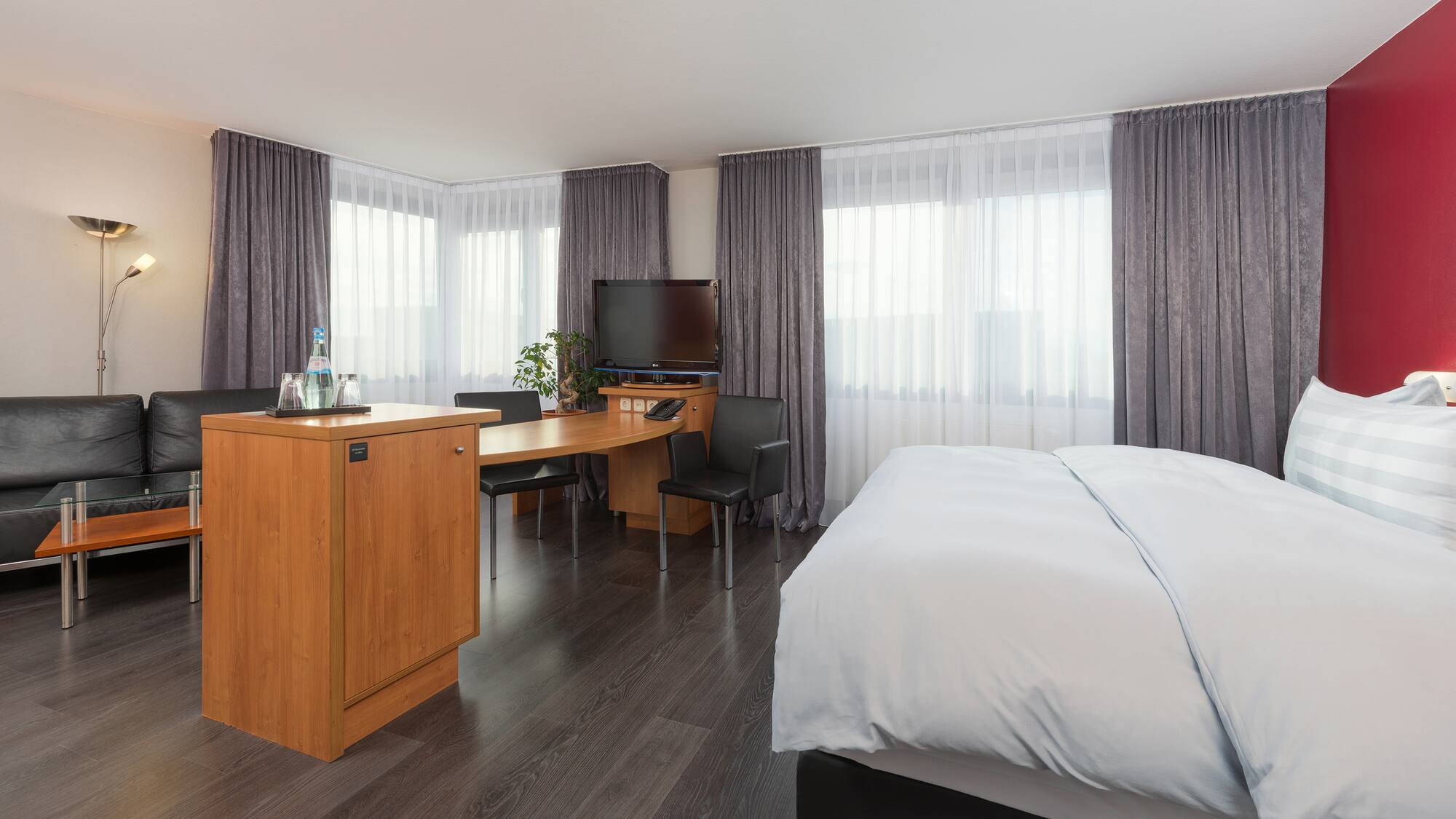 a room with a bed and a desk