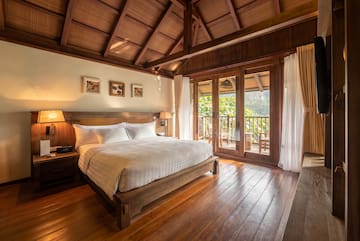 a bedroom with a wood floor and a wooden floor
