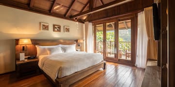 a bedroom with a wood floor and a wooden floor