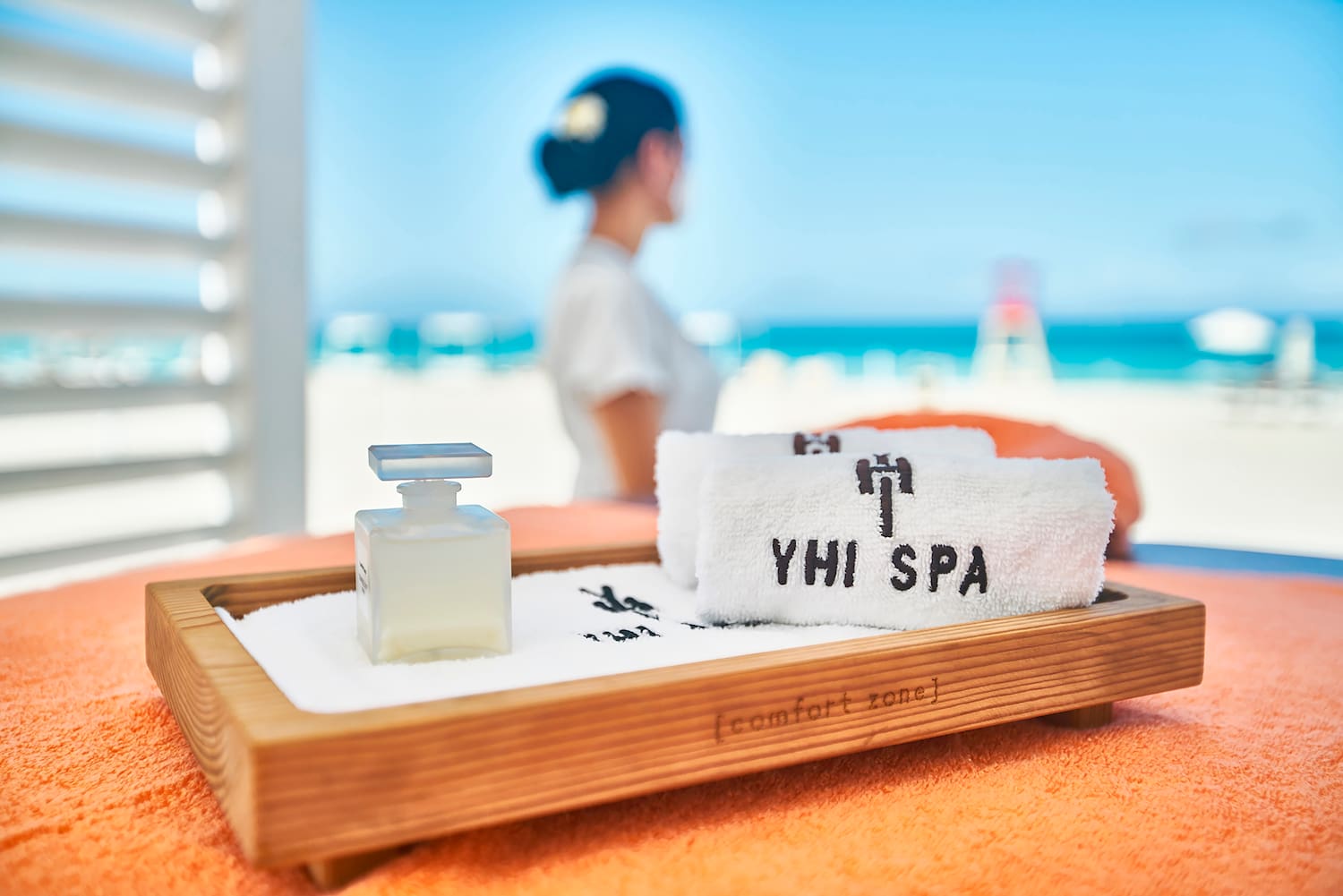 a towel and a bottle on a tray