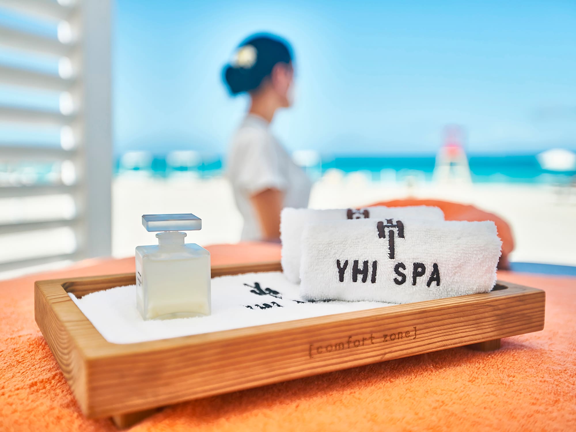 a towel and a bottle on a tray