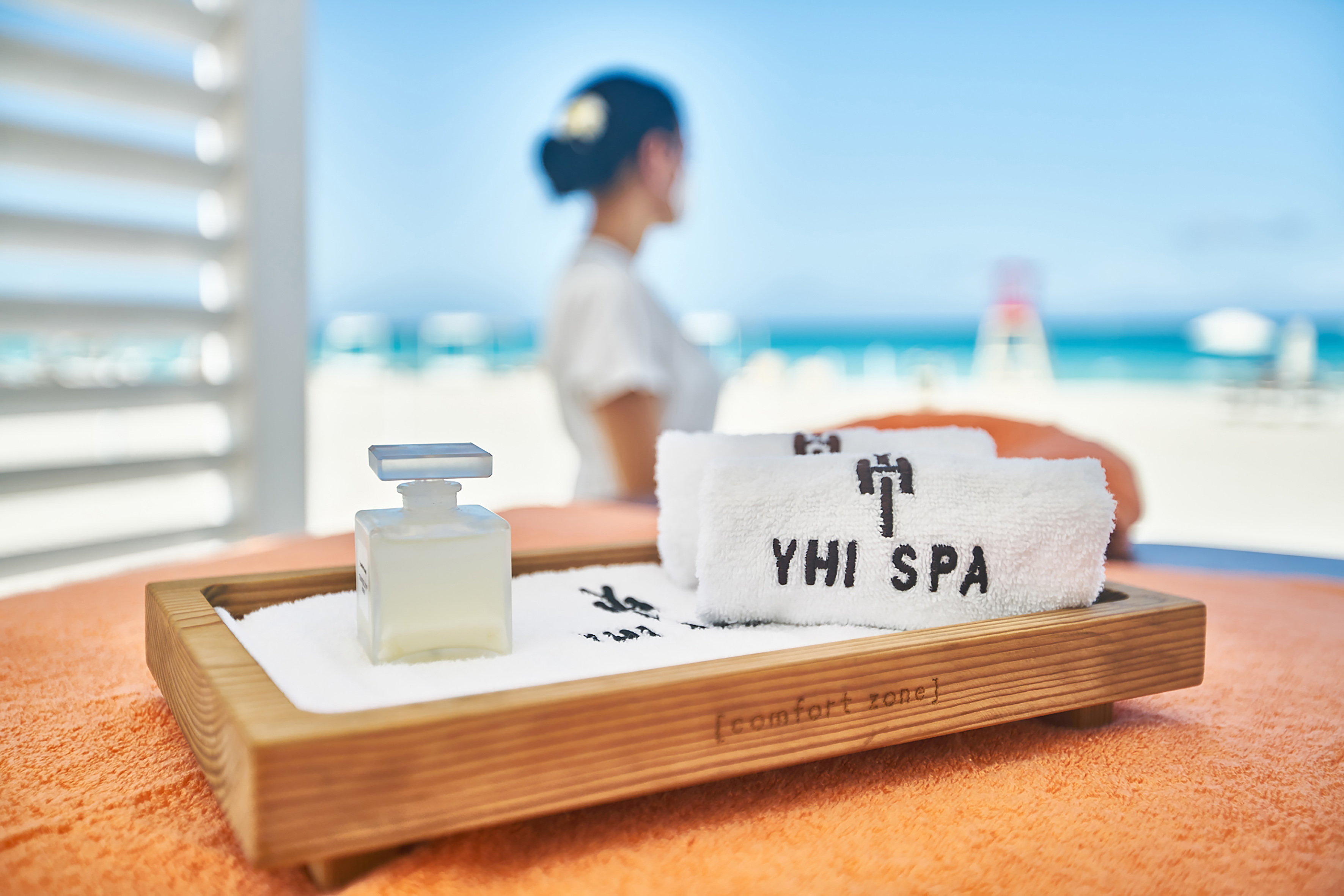 a towel and a bottle on a tray