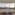 Modern London apartment with panoramic cityscape and London Eye at sunset.