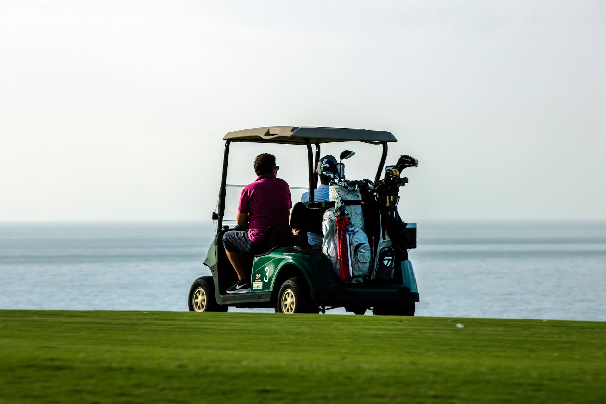 a group of people on a golf cart